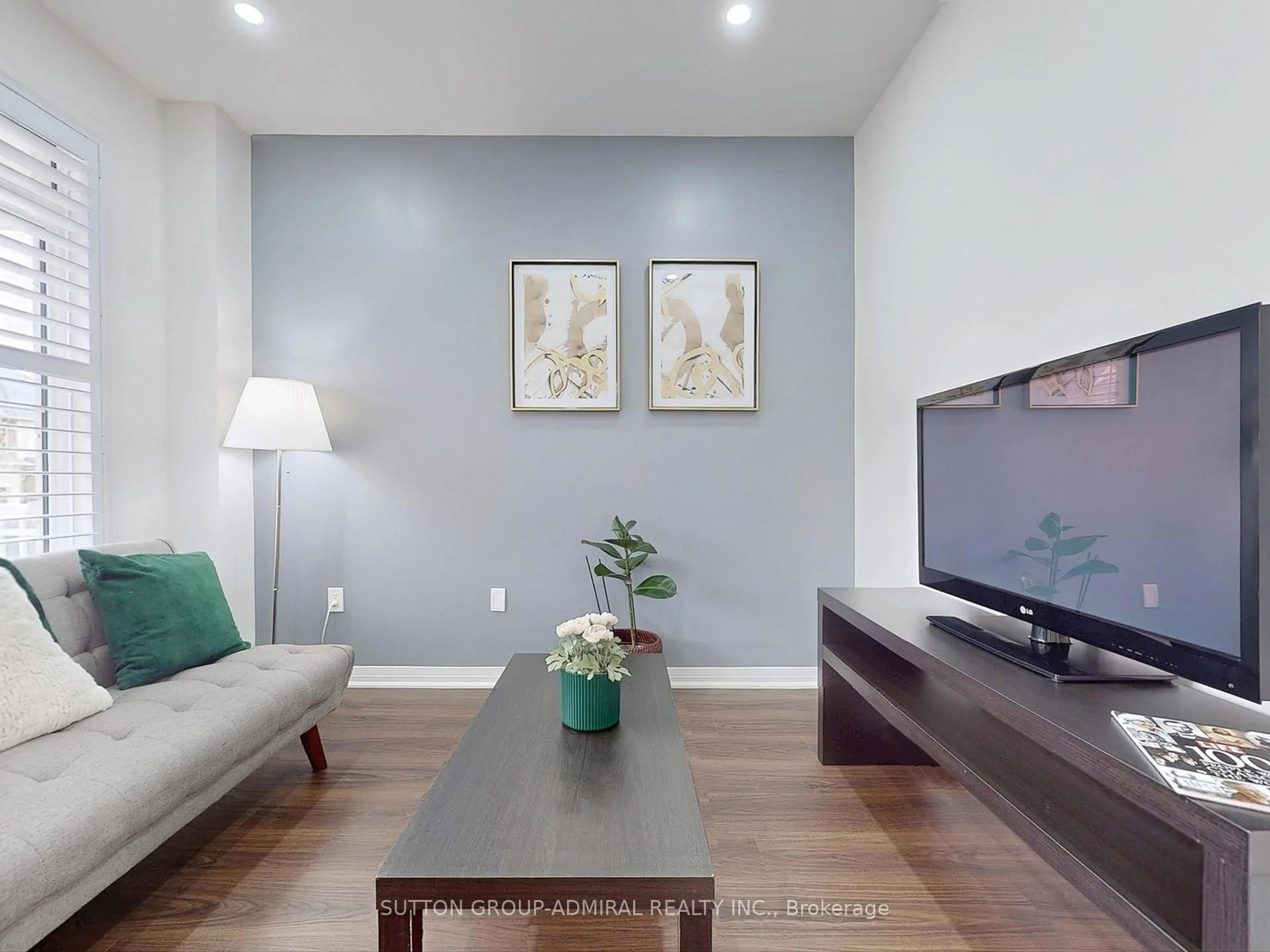 Living room with furniture, wood/laminate floor for 22 Casserley Cres, New Tecumseth Ontario L0G 1W0