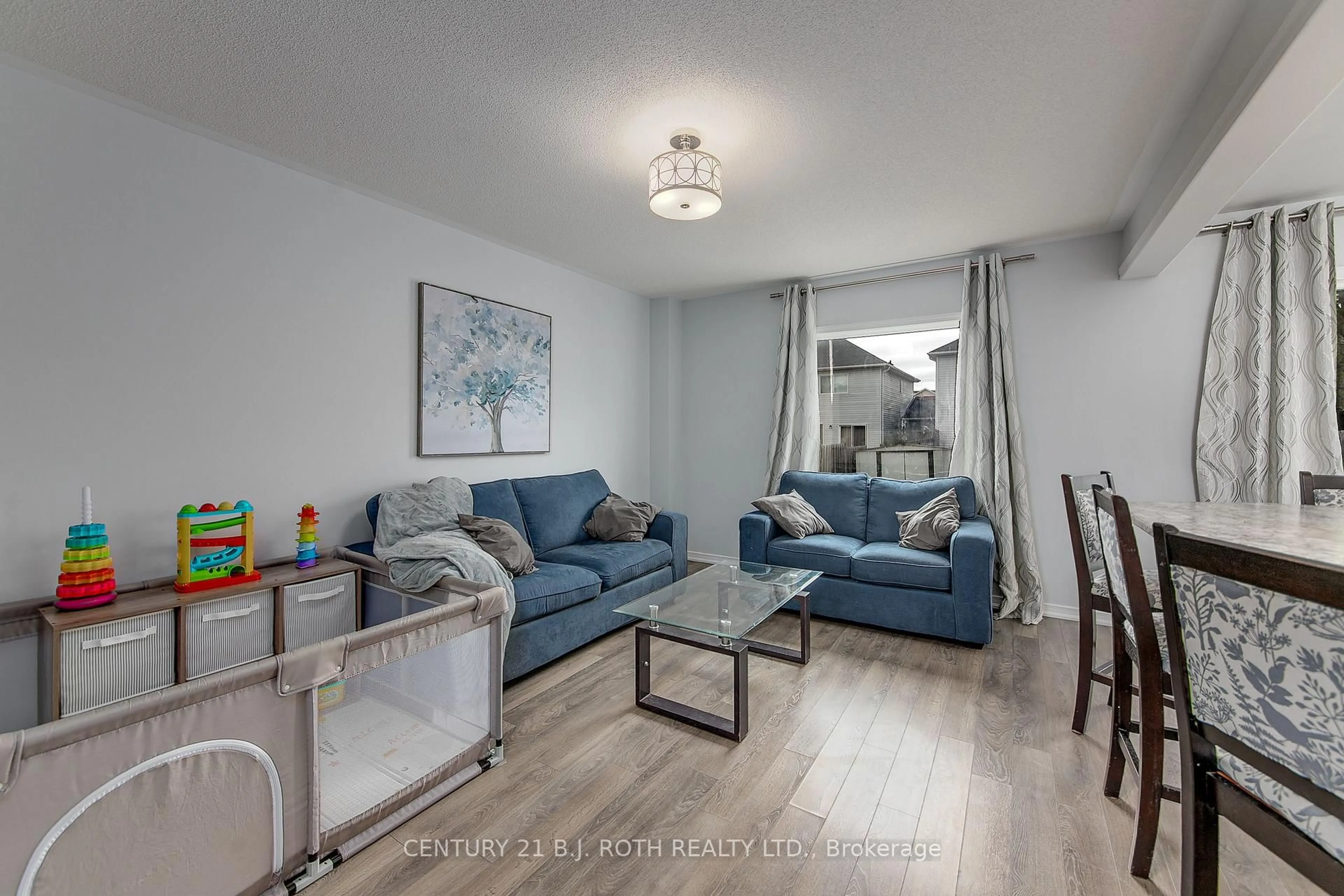 Living room with furniture, wood/laminate floor for 123 Stonemount Cres, Essa Ontario L0M 1B4