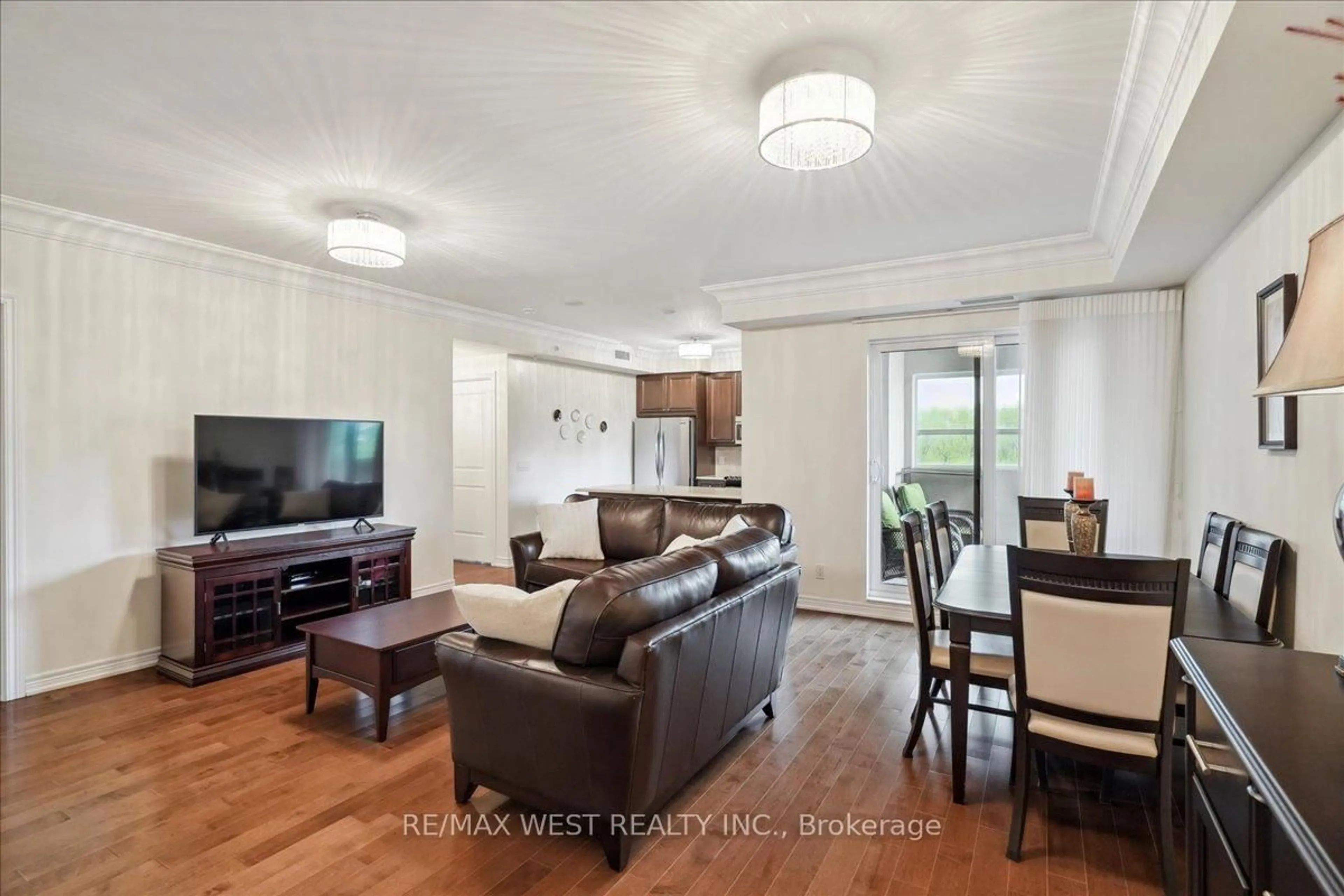 Living room with furniture, wood/laminate floor for 9255 Jane St #405, Vaughan Ontario L6A 0K1