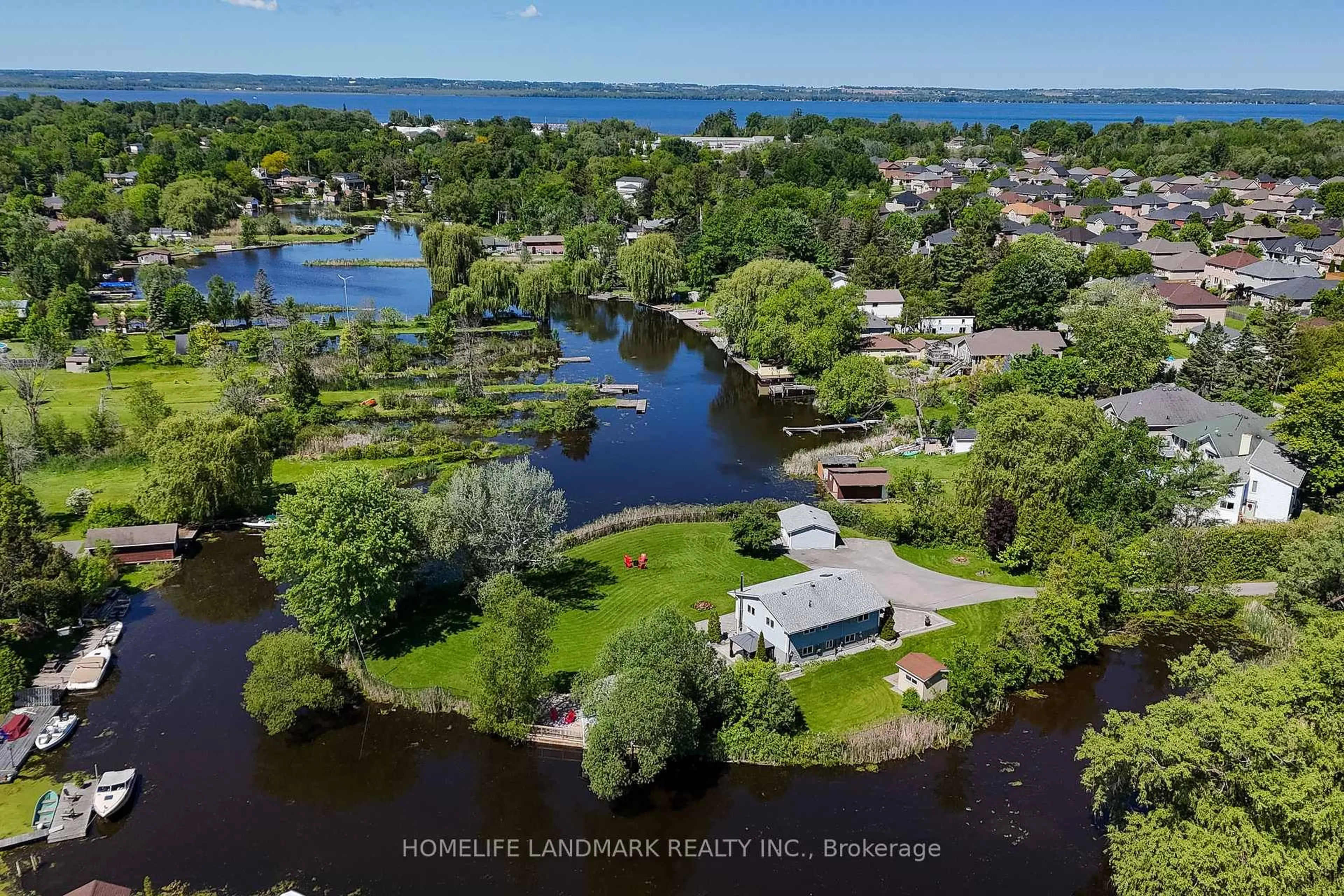 A pic from outside/outdoor area/front of a property/back of a property/a pic from drone, water/lake/river/ocean view for 57 Riveredge Dr, Georgina Ontario L4P 2N8