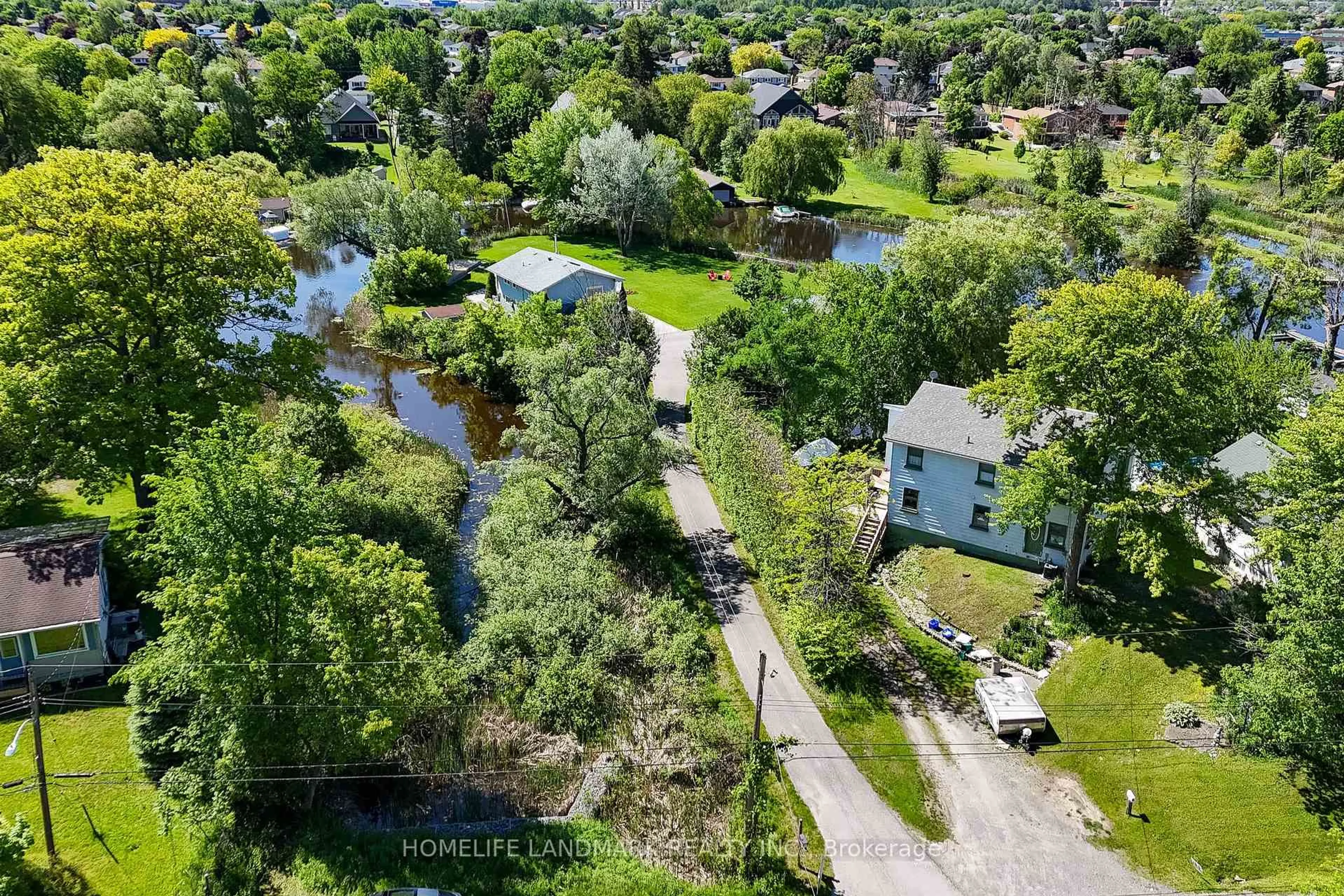 A pic from outside/outdoor area/front of a property/back of a property/a pic from drone, street for 57 Riveredge Dr, Georgina Ontario L4P 2N8