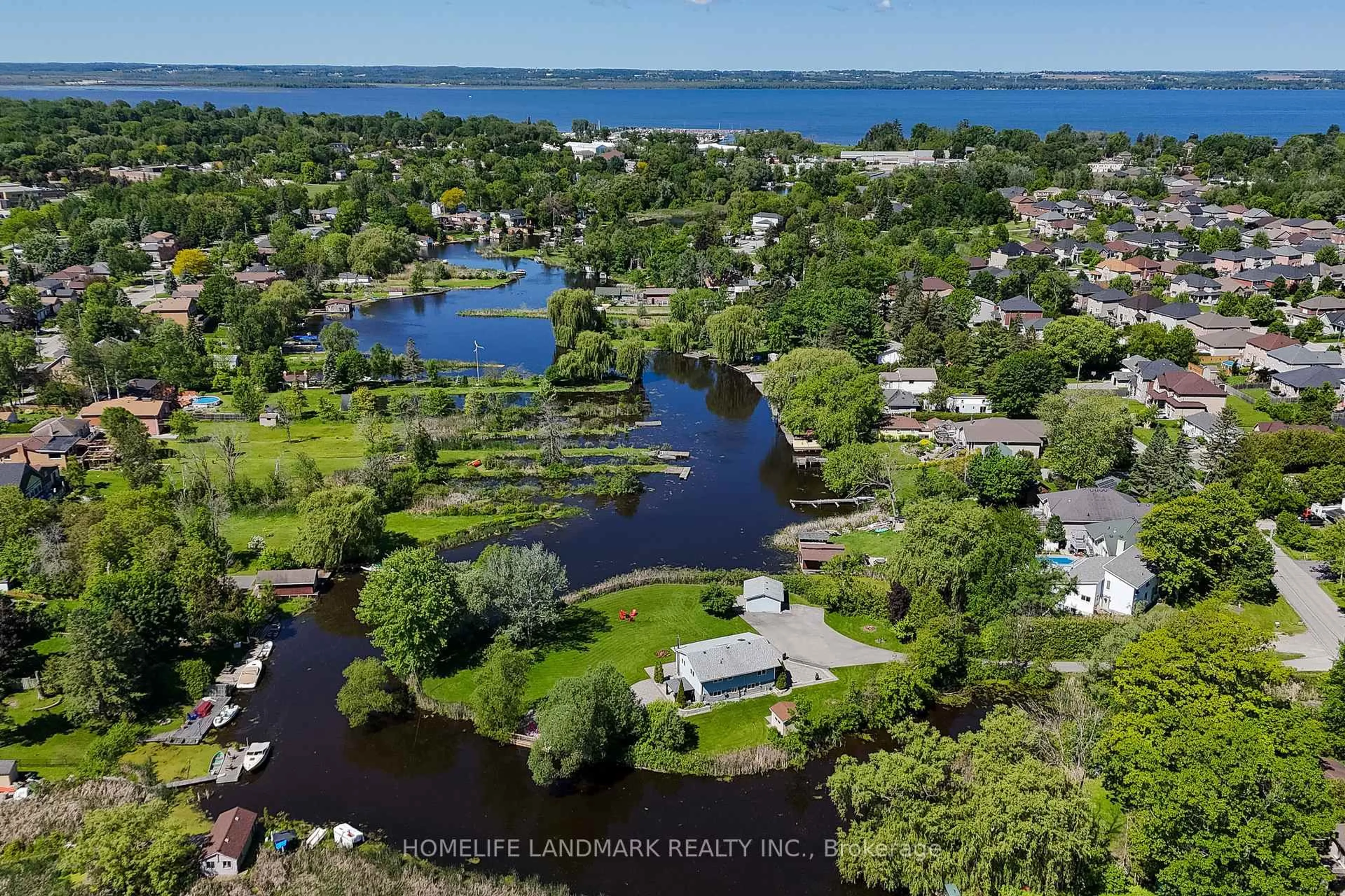 A pic from outside/outdoor area/front of a property/back of a property/a pic from drone, water/lake/river/ocean view for 57 Riveredge Dr, Georgina Ontario L4P 2N8