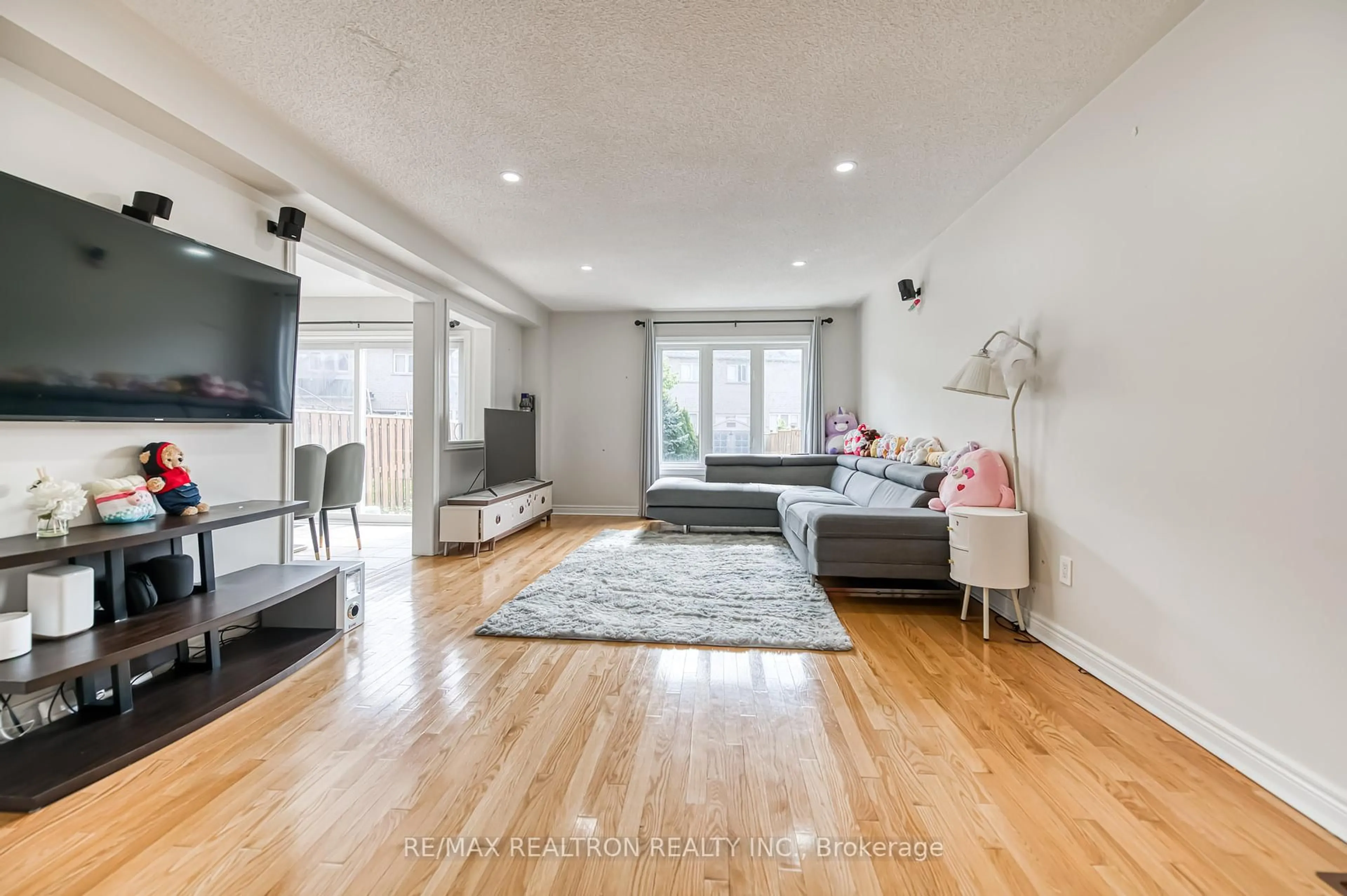 Living room with furniture, wood/laminate floor for 65 Harry Blaylock Dr, Markham Ontario L6E 2H1