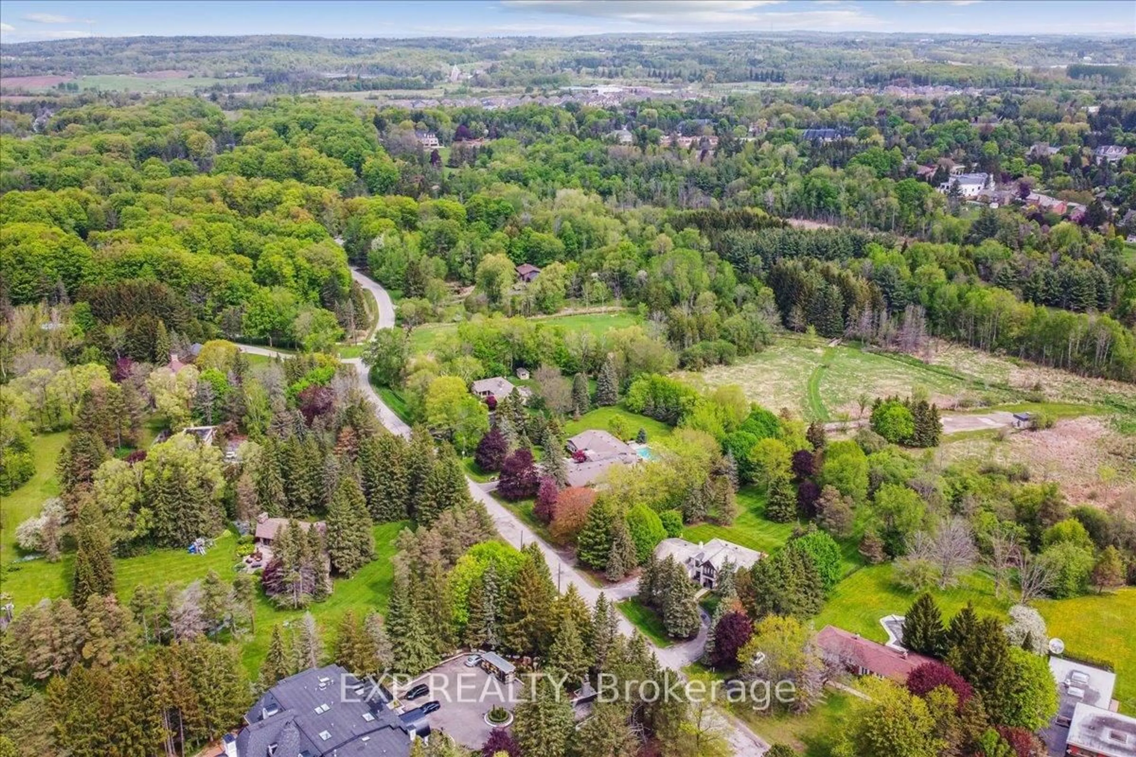 A pic from outside/outdoor area/front of a property/back of a property/a pic from drone, forest/trees view for 71 Manitou Dr, King Ontario L7B 1E7