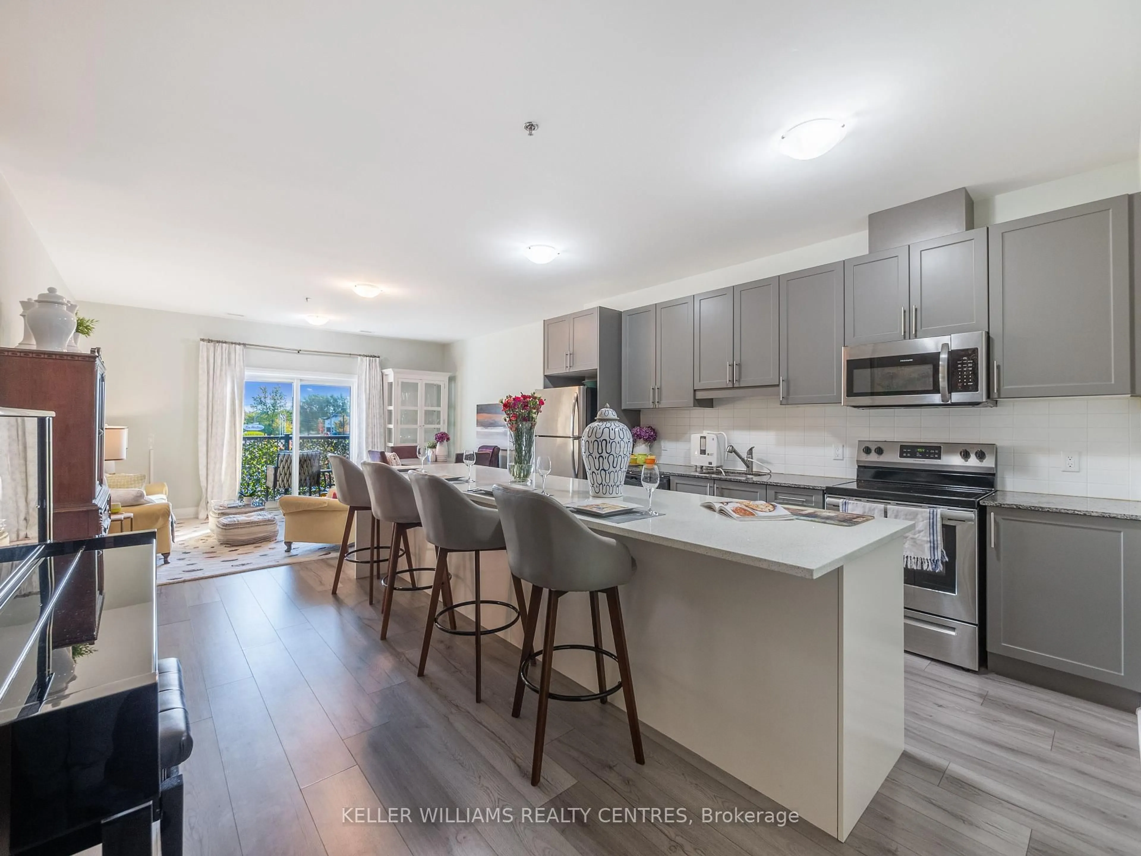 Open concept kitchen, wood/laminate floor for 43 Dale Dr #206, New Tecumseth Ontario L0G 1A0