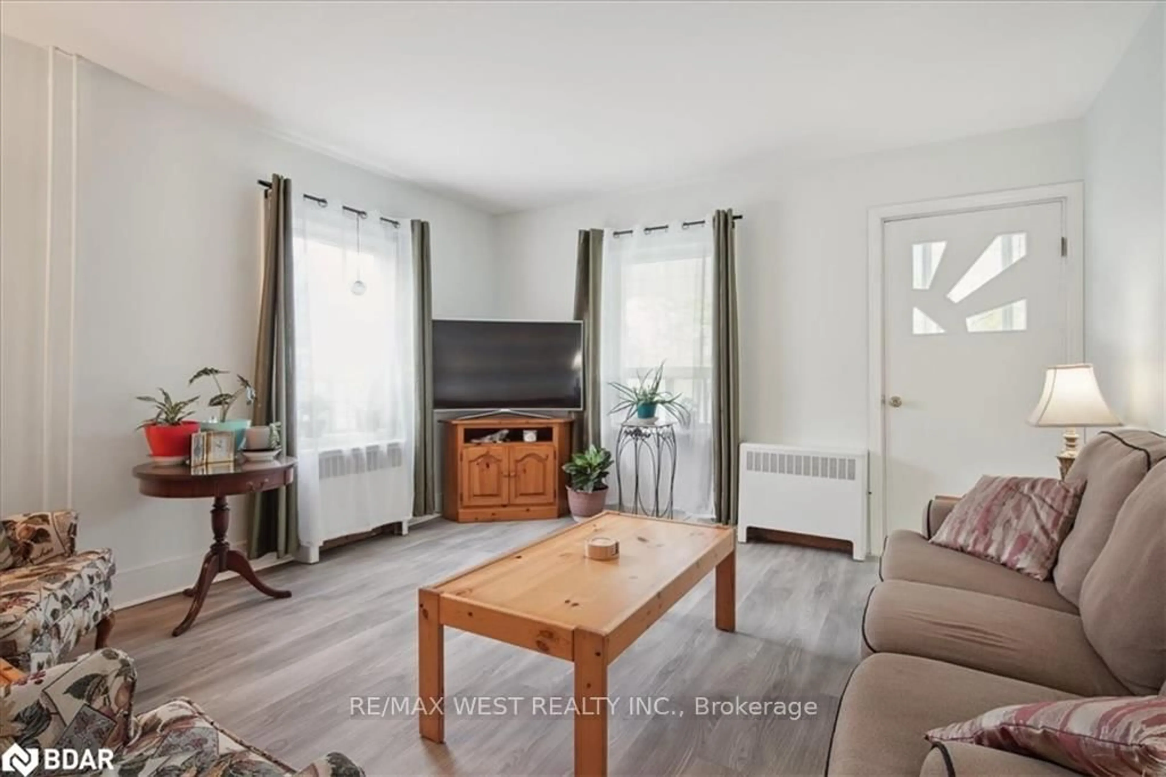 Living room with furniture, wood/laminate floor for 55 River St, Georgina Ontario L0E 1R0