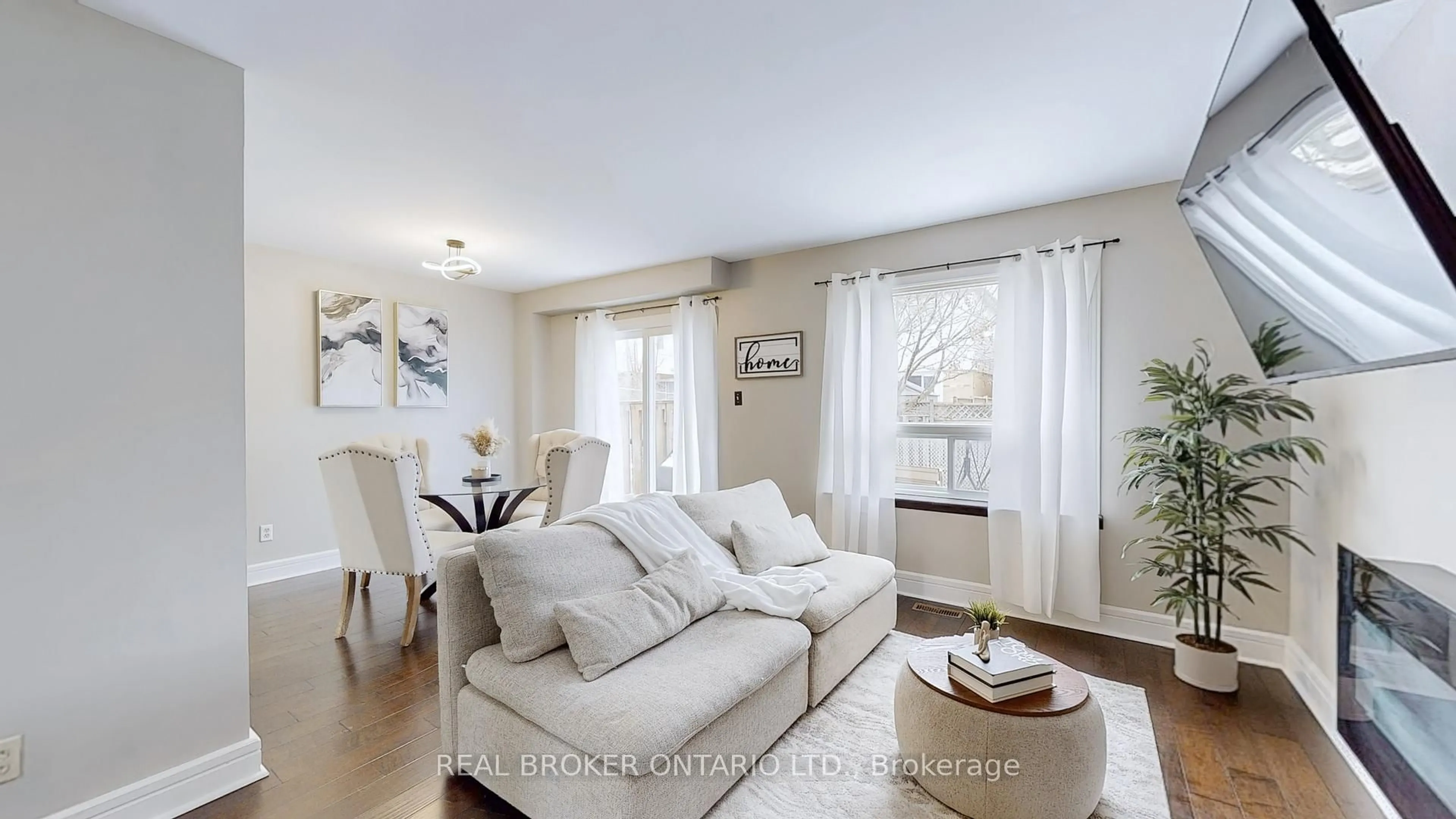 Living room with furniture, wood/laminate floor for 1200 Inniswood St, Innisfil Ontario L9S 1X7