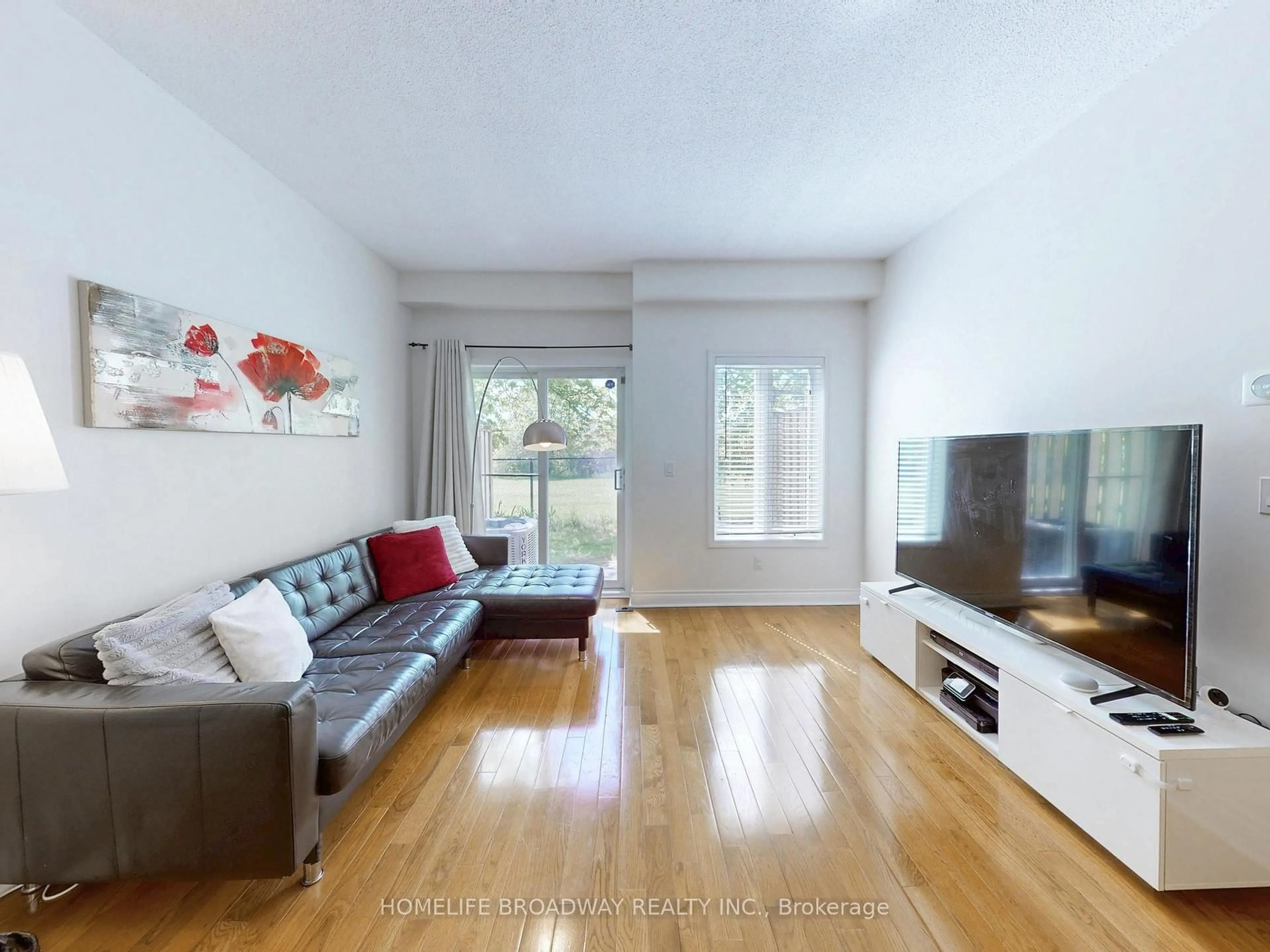 Living room with furniture, wood/laminate floor for 8 St Moritz Way #3A, Markham Ontario L3R 4E8