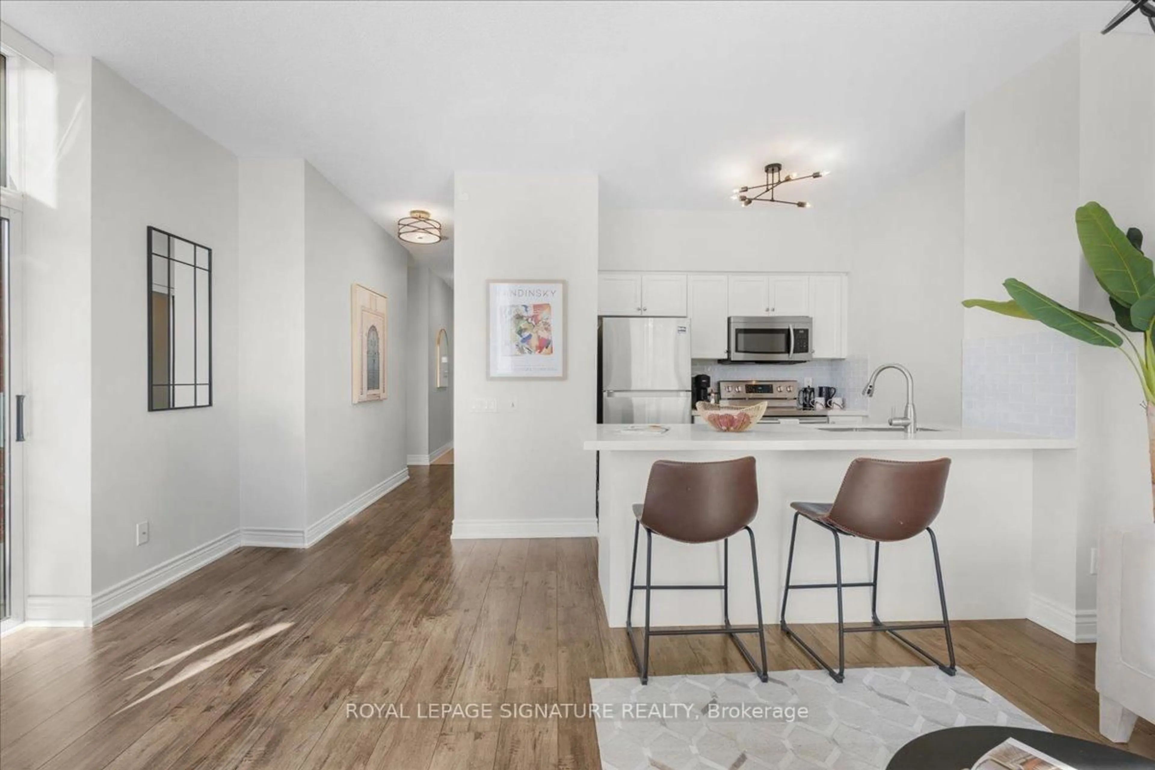 Open concept kitchen, wood/laminate floor for 25 Times Ave #108, Markham Ontario L3T 7X5