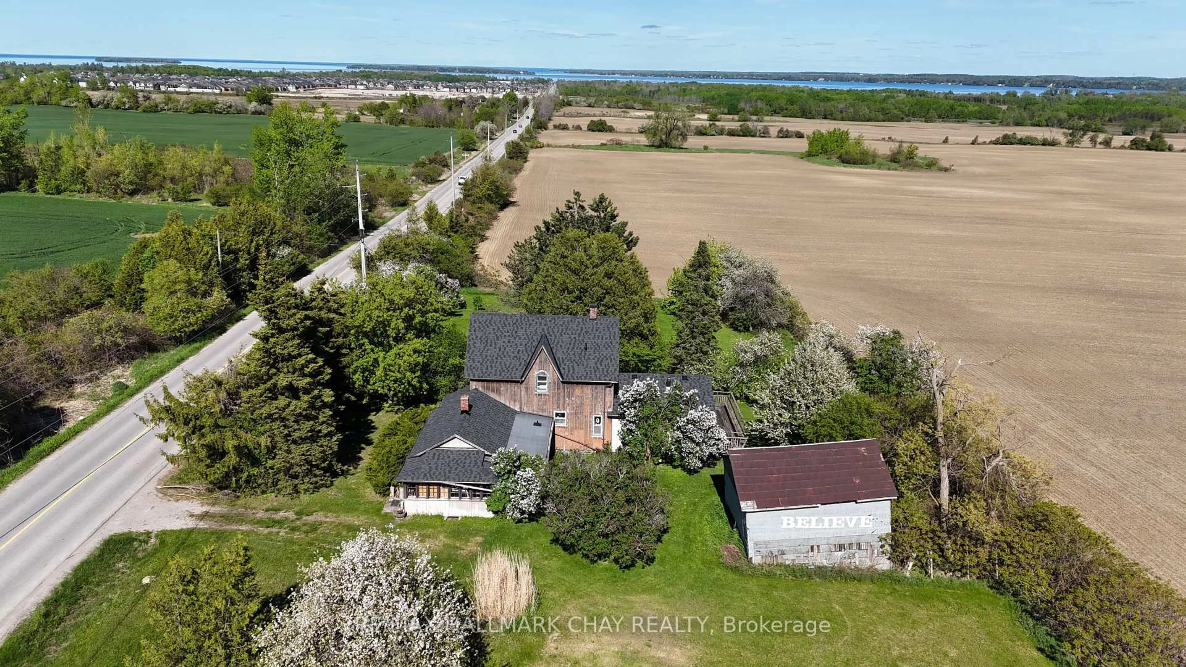 A pic from outside/outdoor area/front of a property/back of a property/a pic from drone, water/lake/river/ocean view for 1475 6th Line, Innisfil Ontario L9S 4R2