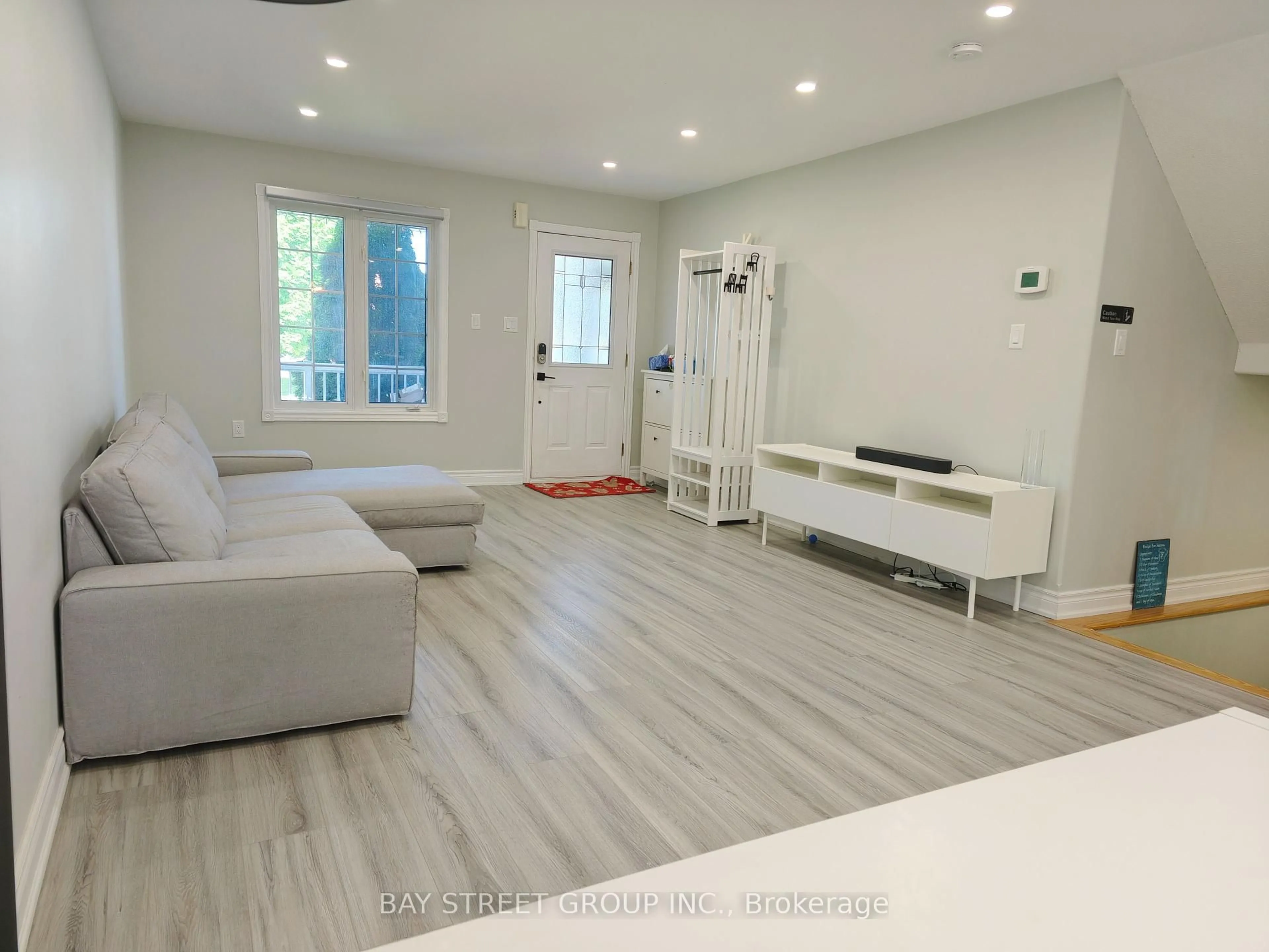 Living room with furniture, wood/laminate floor for 18 Wrendale Cres, Georgina Ontario L4P 4C4