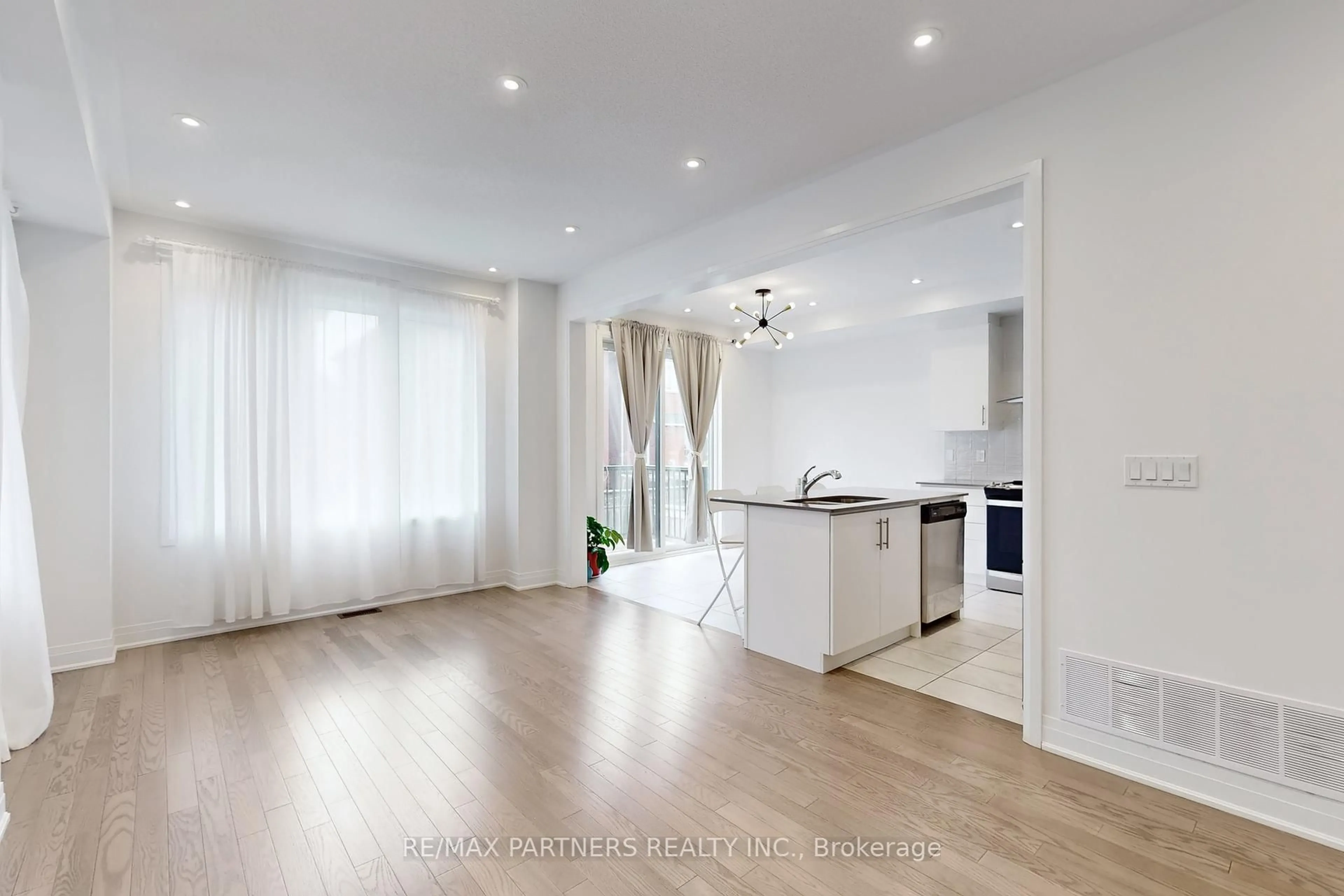 Open concept kitchen, wood/laminate floor for 14 Arthur White Lane, Markham Ontario L6E 0W2
