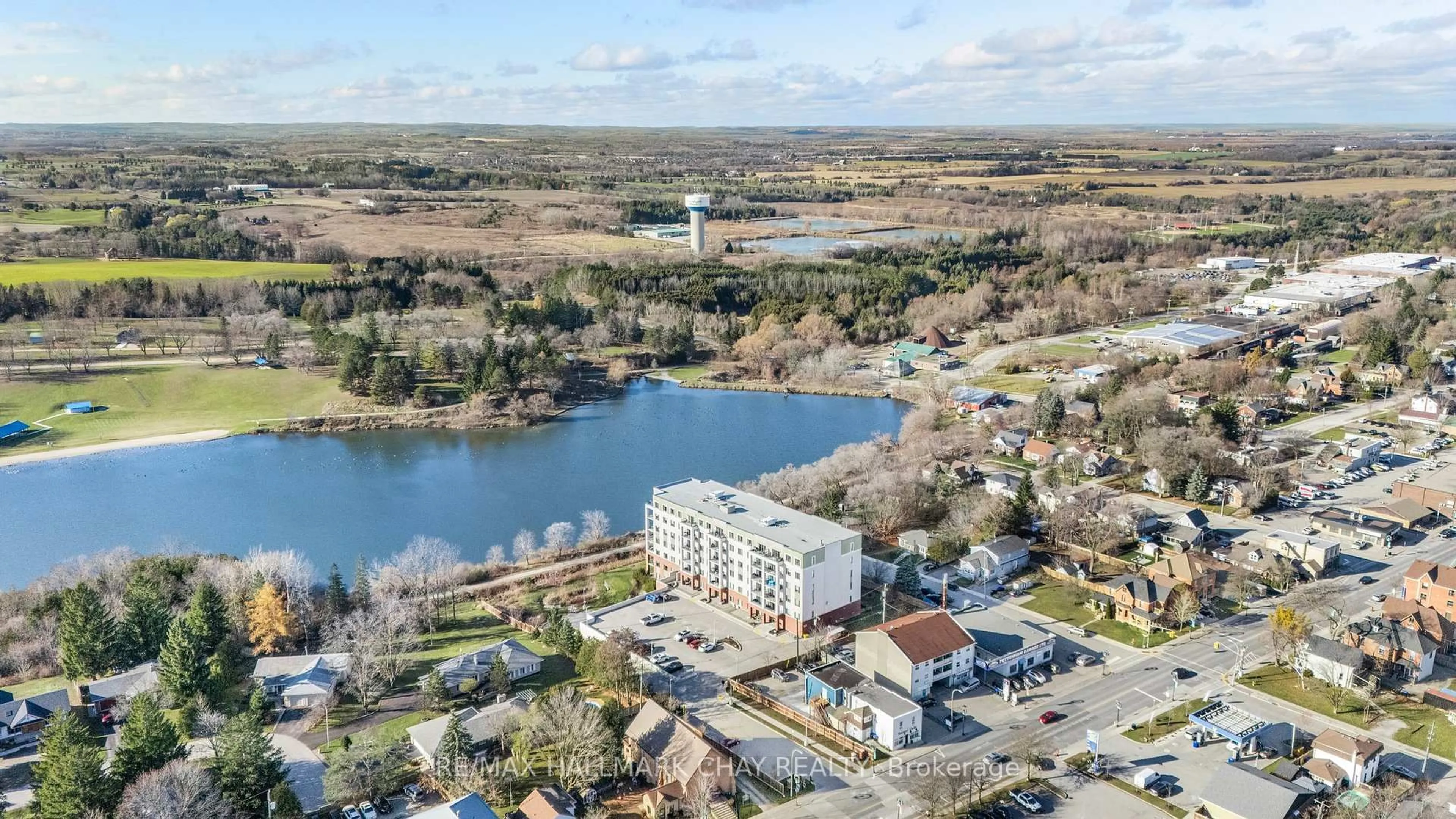 A pic from outside/outdoor area/front of a property/back of a property/a pic from drone, water/lake/river/ocean view for 64 Queen St #107, New Tecumseth Ontario L0G 1W0