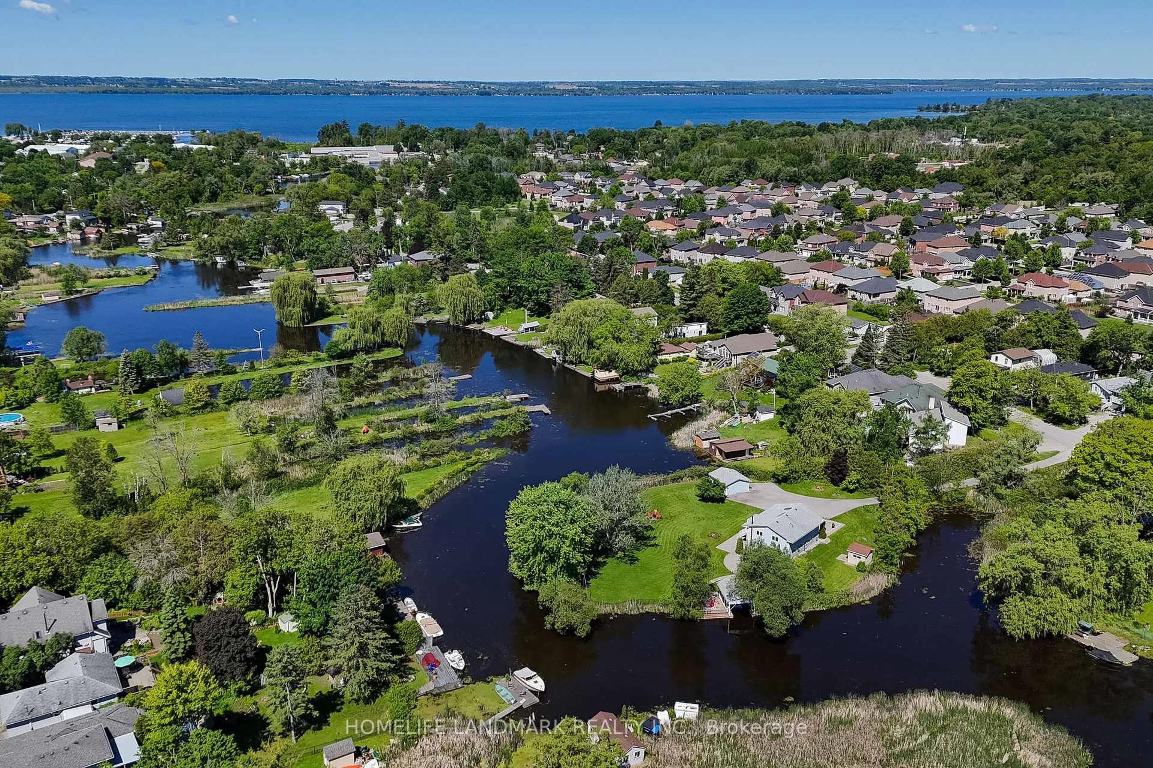 A pic from outside/outdoor area/front of a property/back of a property/a pic from drone, water/lake/river/ocean view for 57 Riveredge Dr, Georgina Ontario L4P 2N8