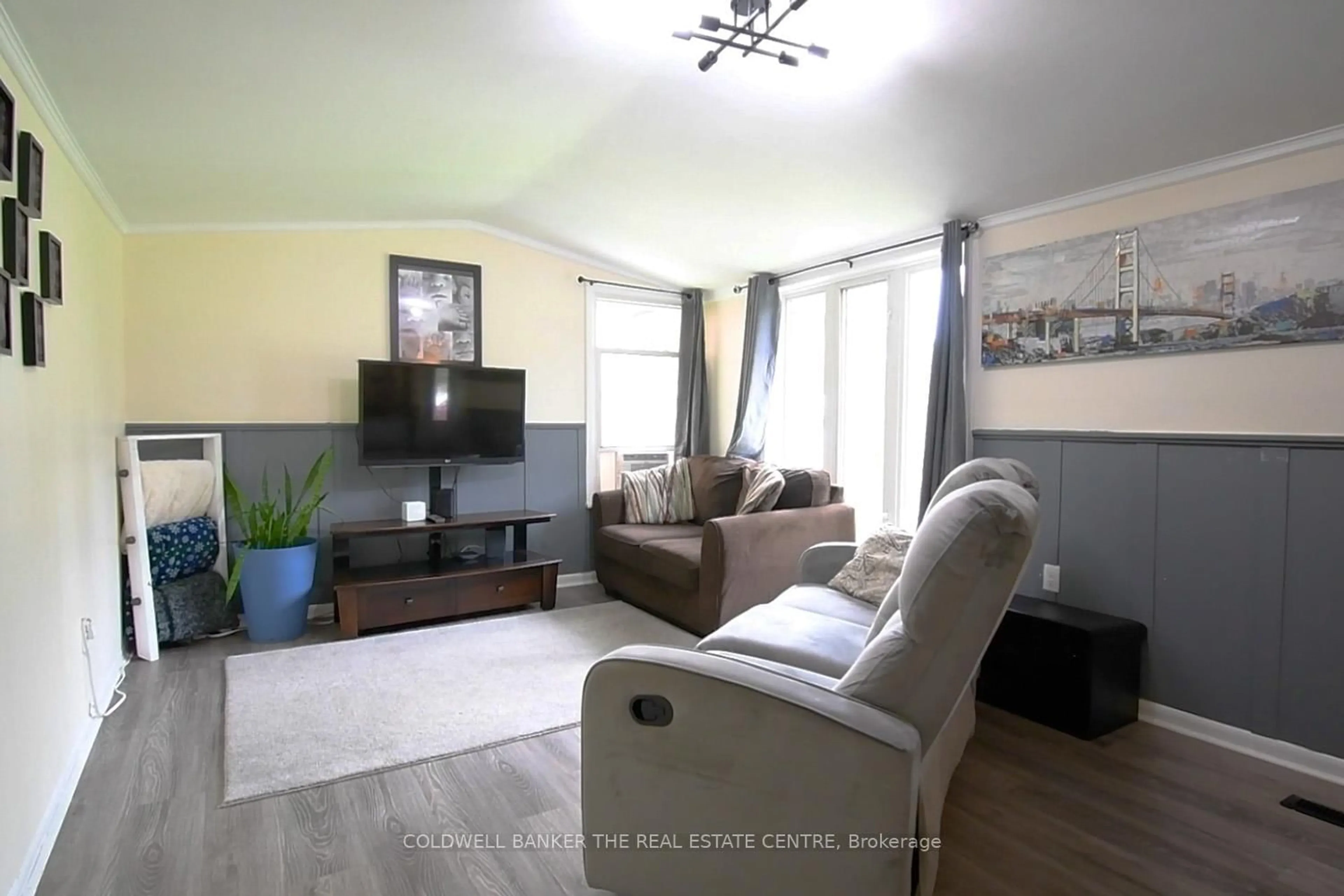 Living room with furniture, wood/laminate floor for 119 Elizabeth St, Essa Ontario L0M 1B0