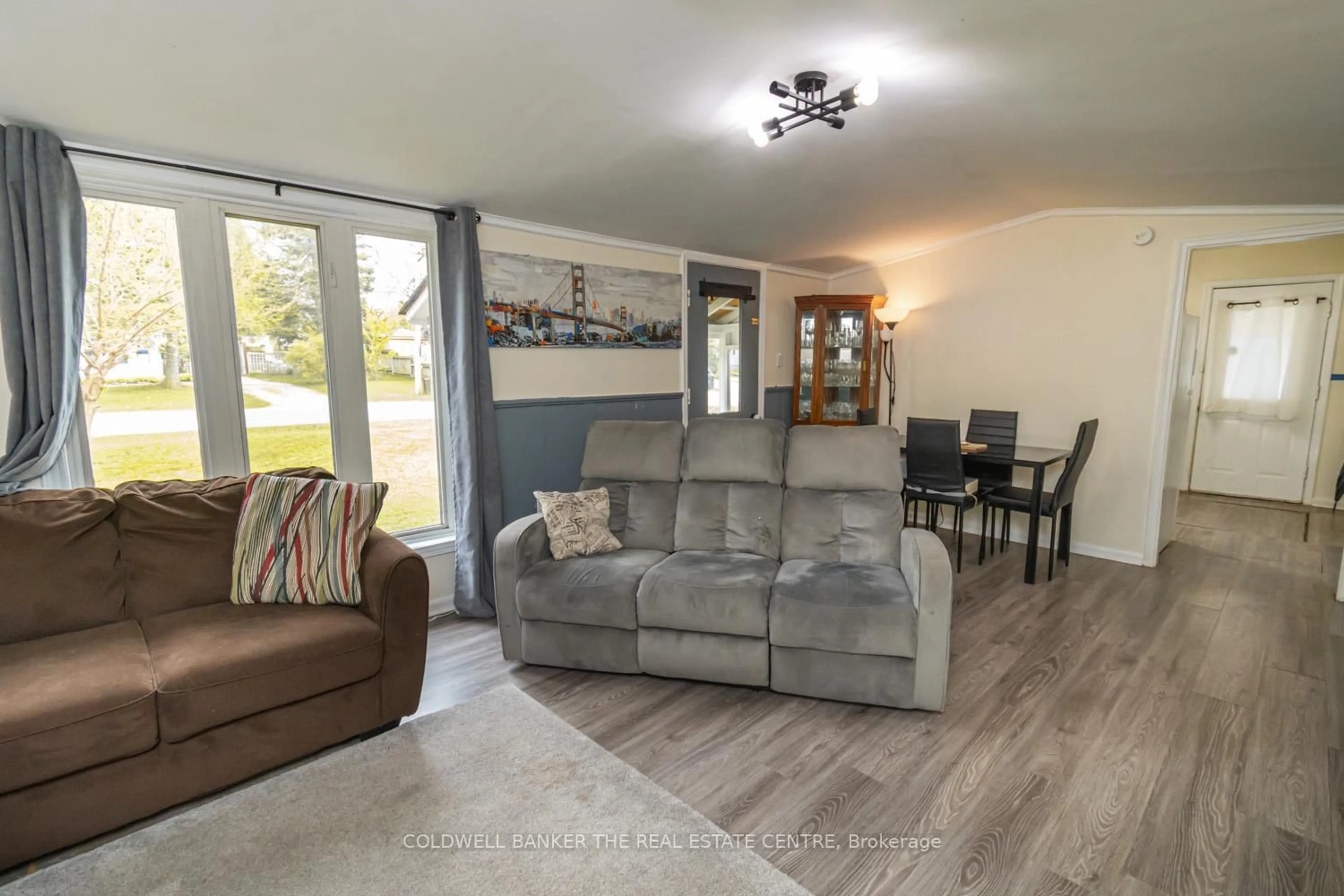Living room with furniture, wood/laminate floor for 119 Elizabeth St, Essa Ontario L0M 1B0