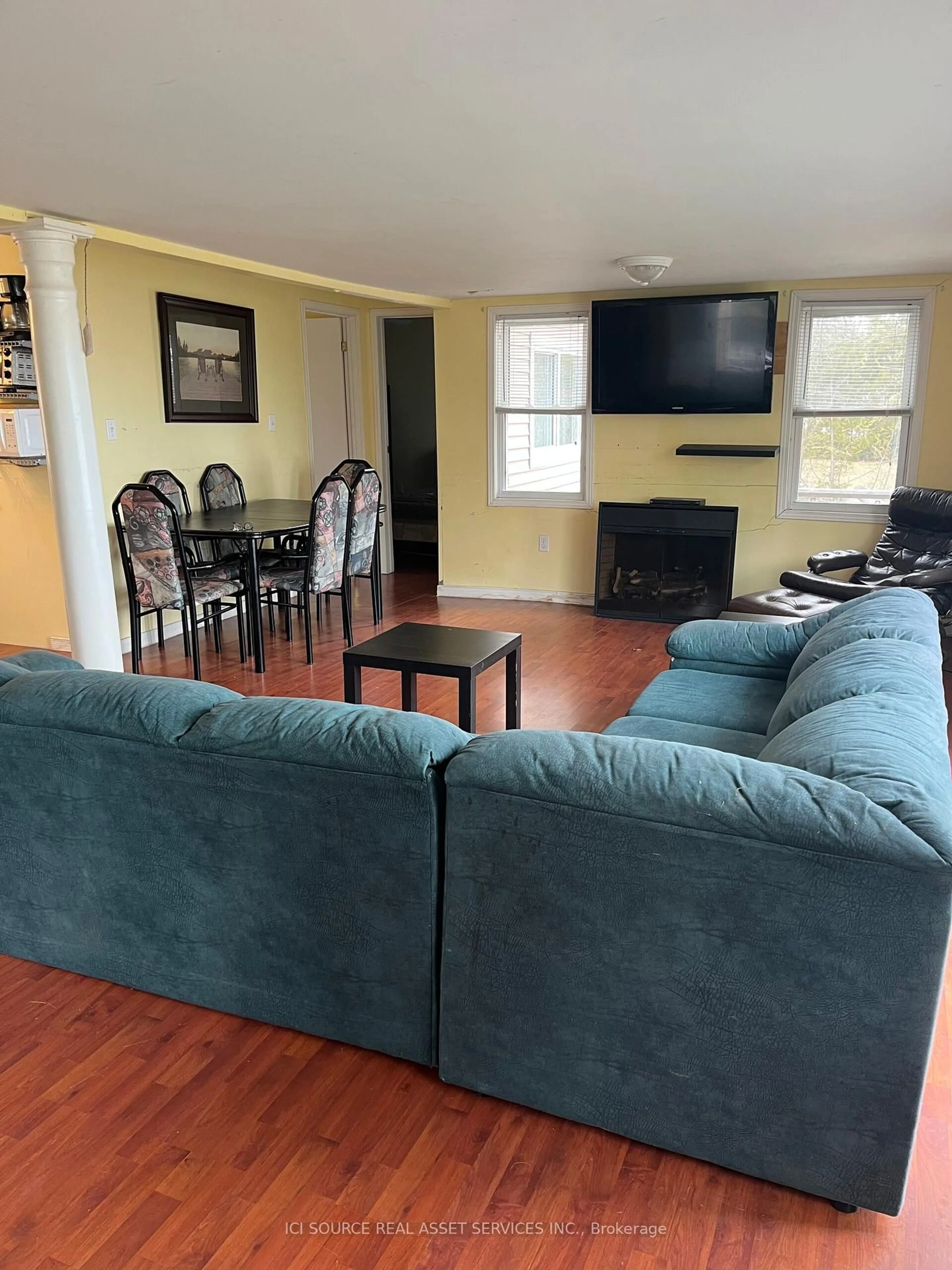 Living room with furniture, wood/laminate floor for 704 Loon Rd, Georgina Islands Ontario L0E 1R0