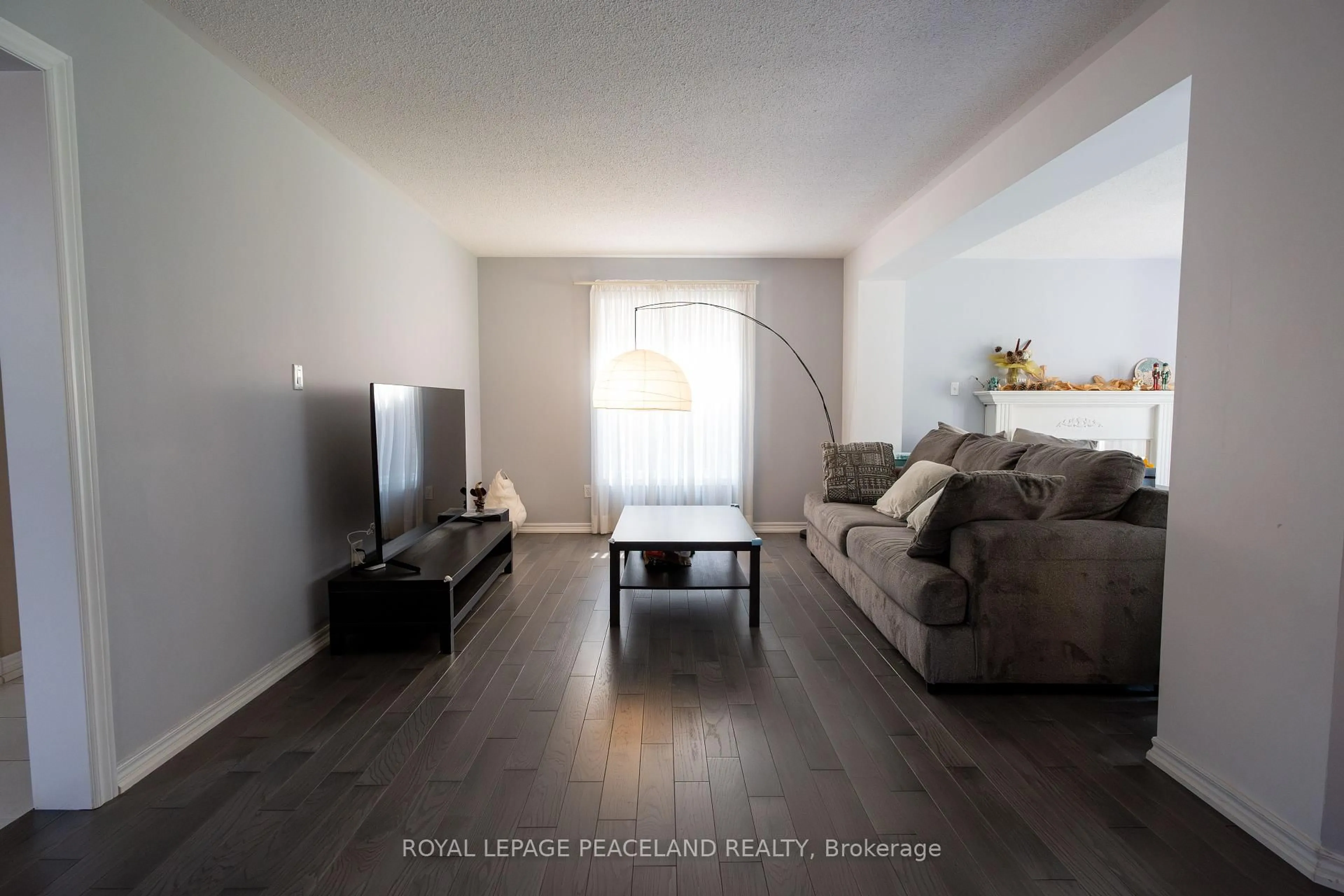 Living room with furniture, wood/laminate floor for 107 Quince Cres, Markham Ontario L3S 3T7