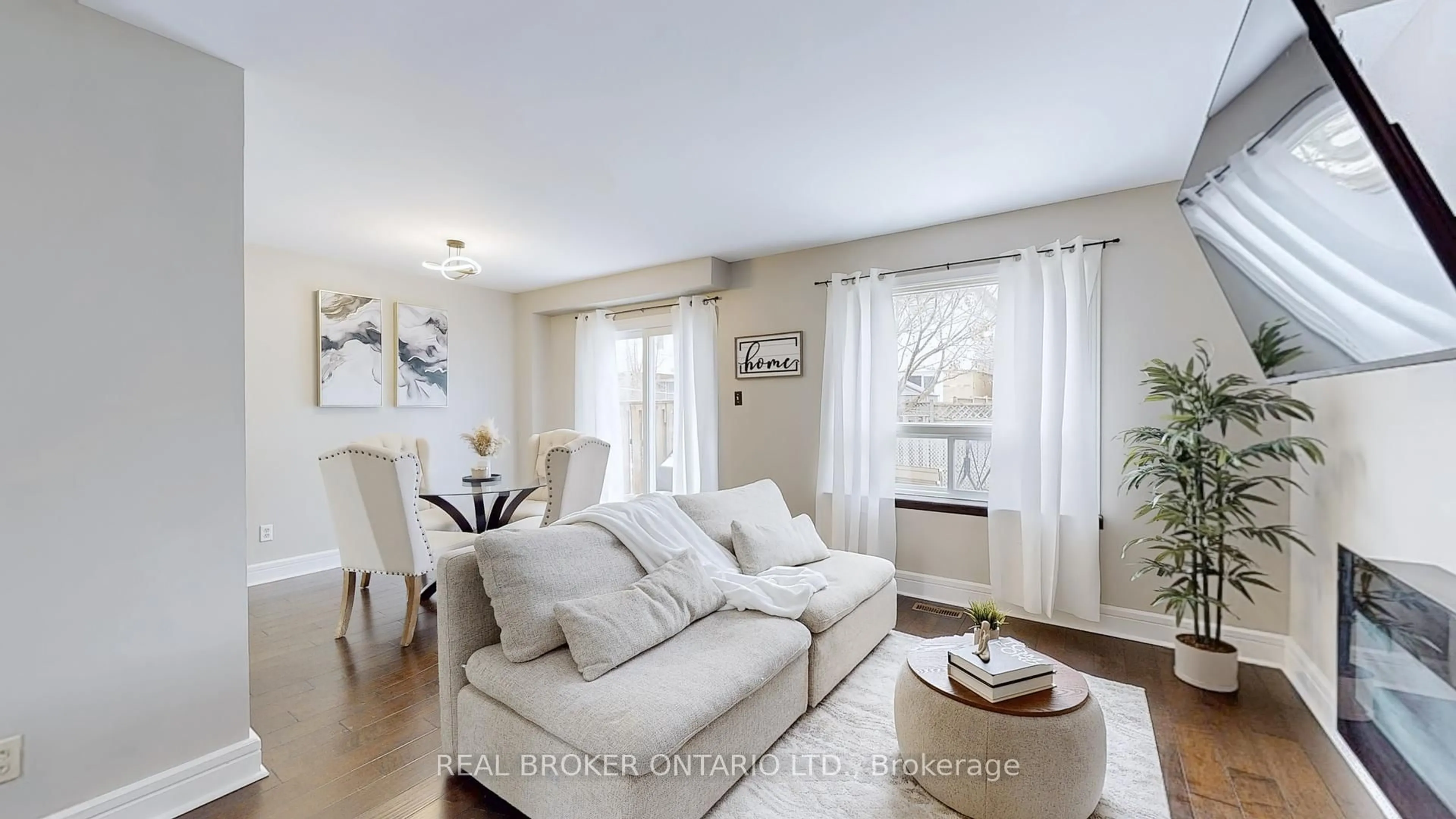 Living room with furniture, wood/laminate floor for 1200 Inniswood St, Innisfil Ontario L9S 1X7