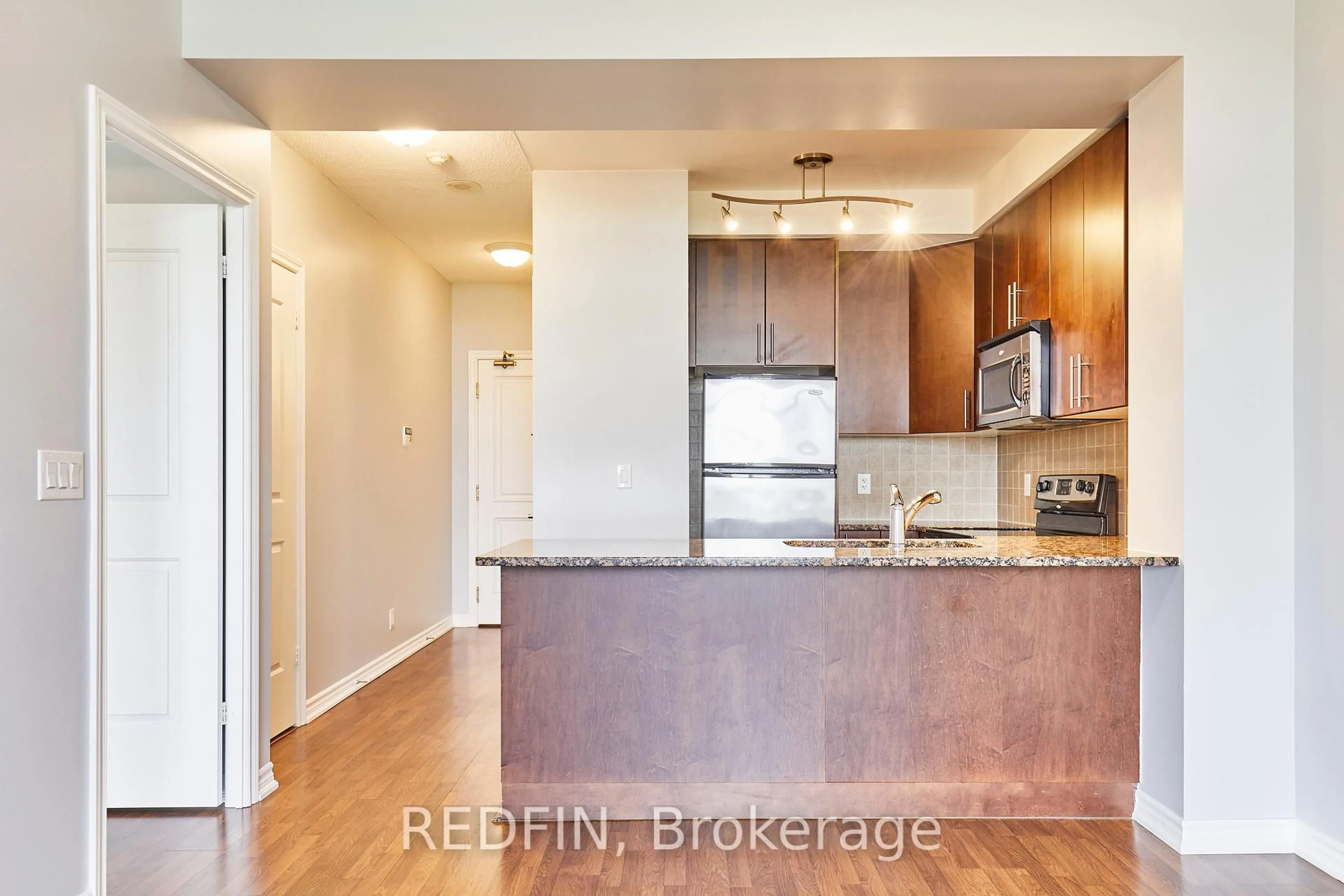 Open concept kitchen, wood/laminate floor for 9235 Jane St #1016, Vaughan Ontario L6A 0J8