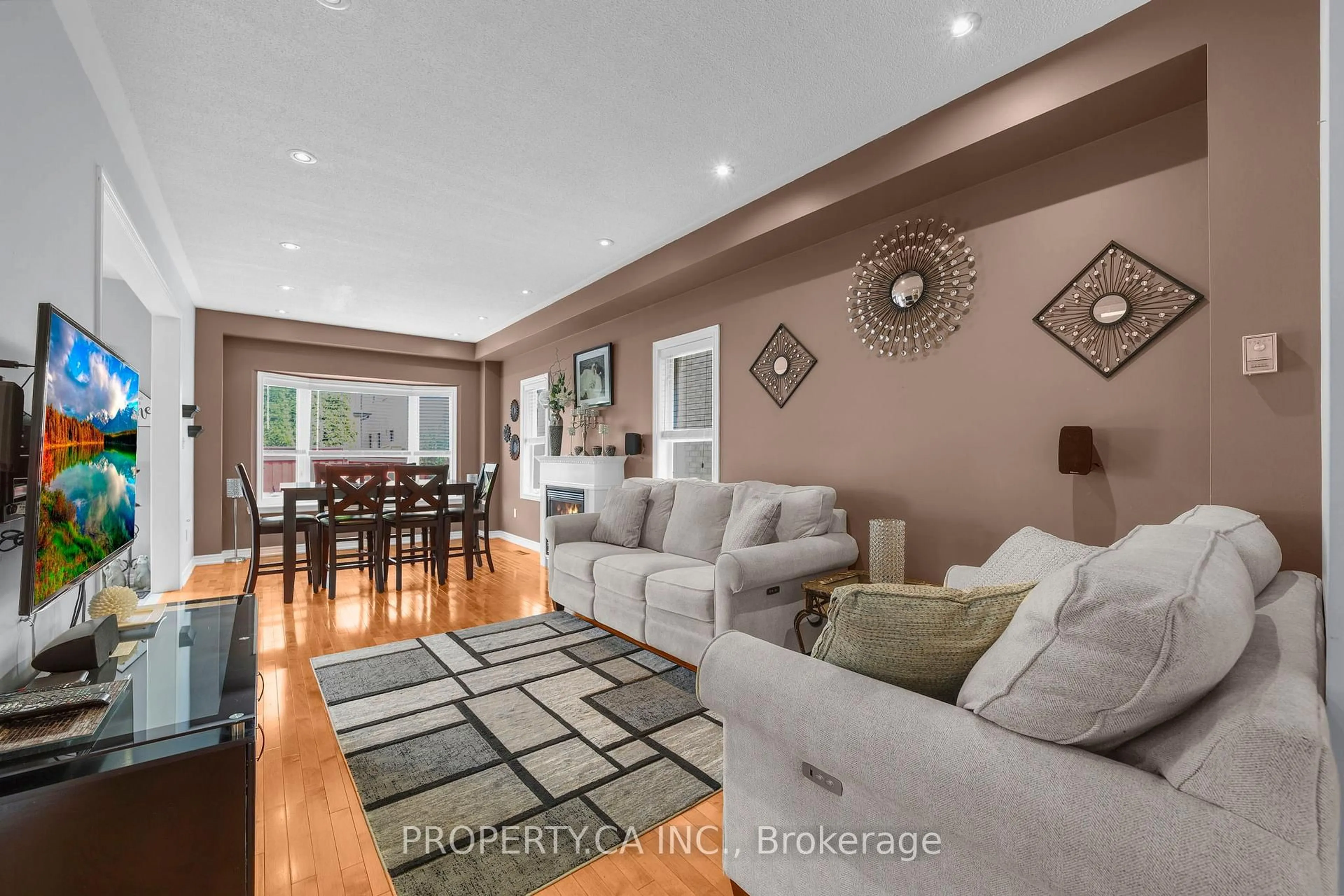 Living room with furniture, wood/laminate floor for 25 Boticelli Way, Vaughan Ontario L4H 0C6