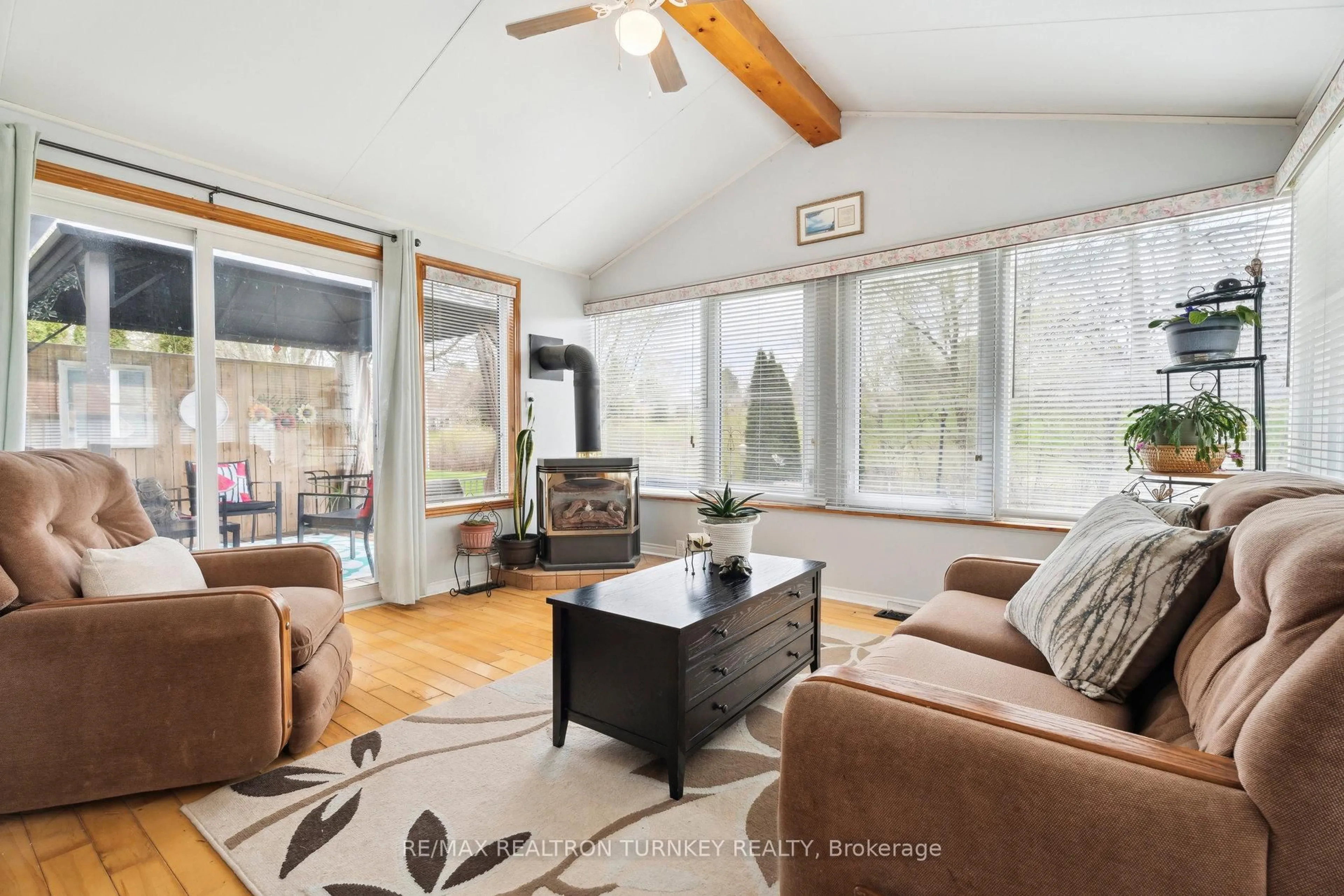 Living room with furniture, wood/laminate floor for 36 Tecumseth Pines Dr, New Tecumseth Ontario L0G 1W0