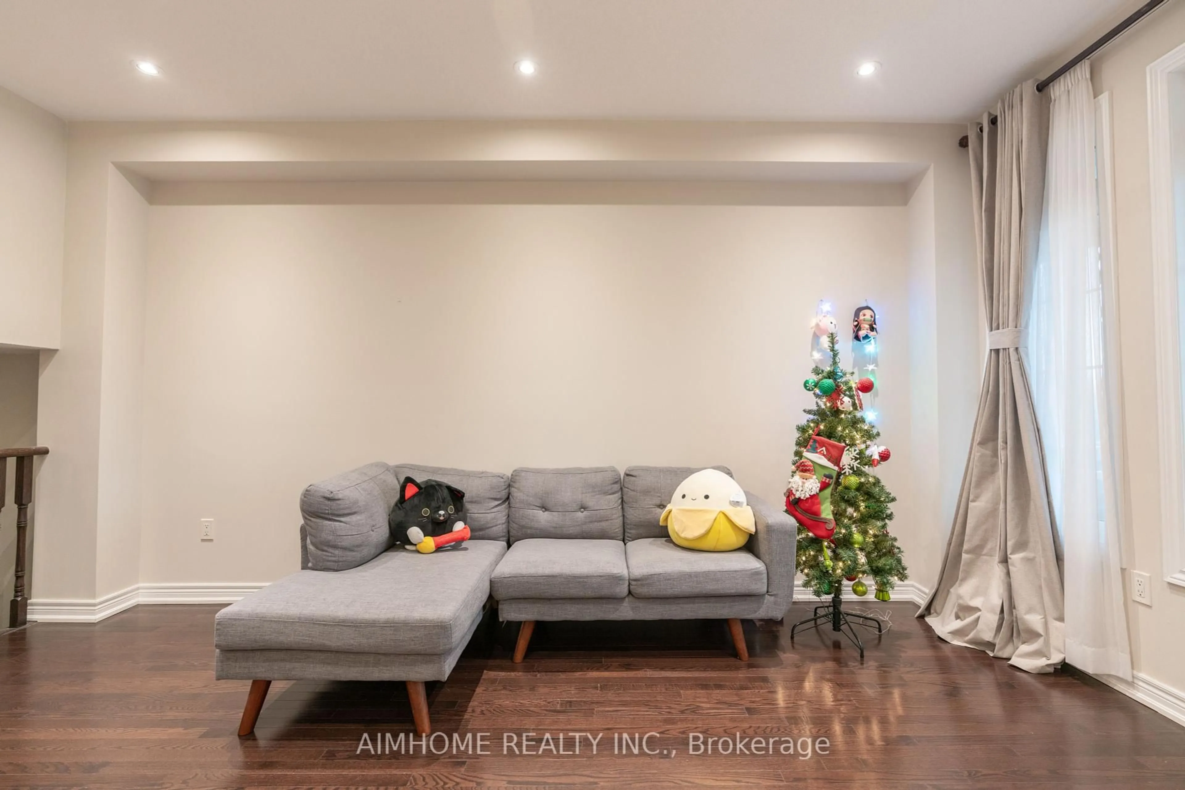 Living room with furniture, wood/laminate floor for 934 Castlemore Ave, Markham Ontario L6E 0N3