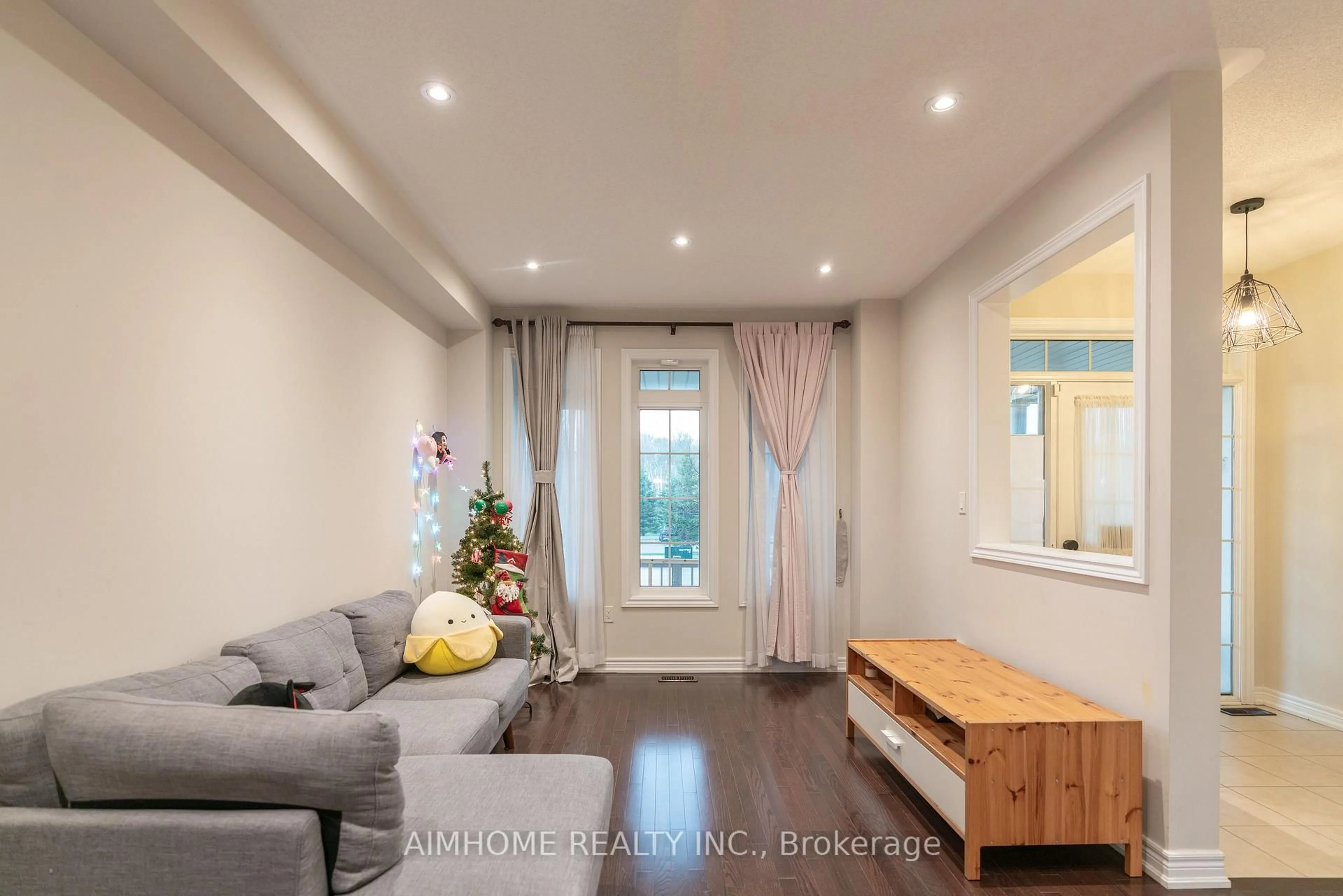 Living room with furniture, wood/laminate floor for 934 Castlemore Ave, Markham Ontario L6E 0N3