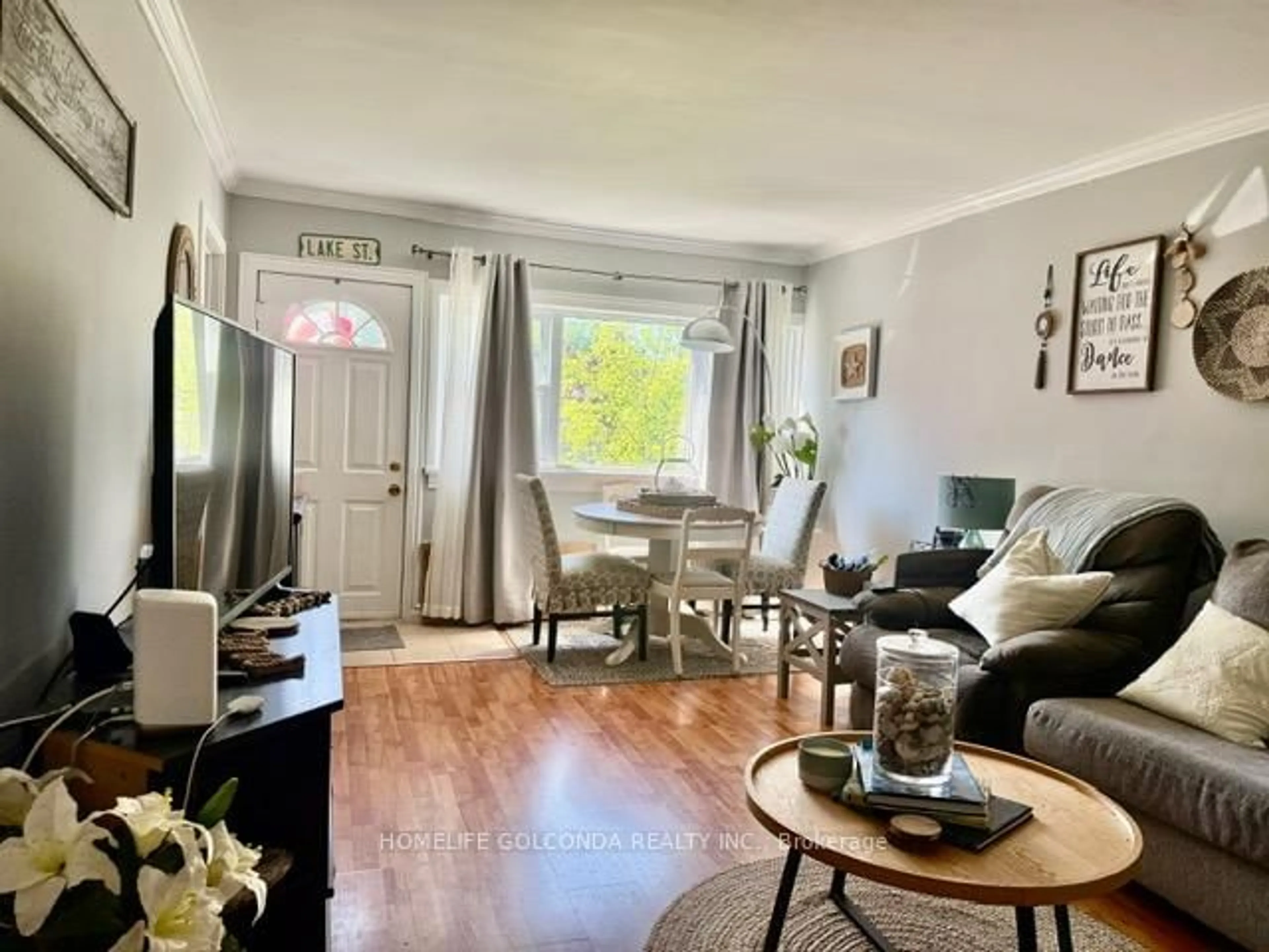 Living room with furniture, wood/laminate floor for 240 Pine Beach Dr, Georgina Ontario L4P 2B5