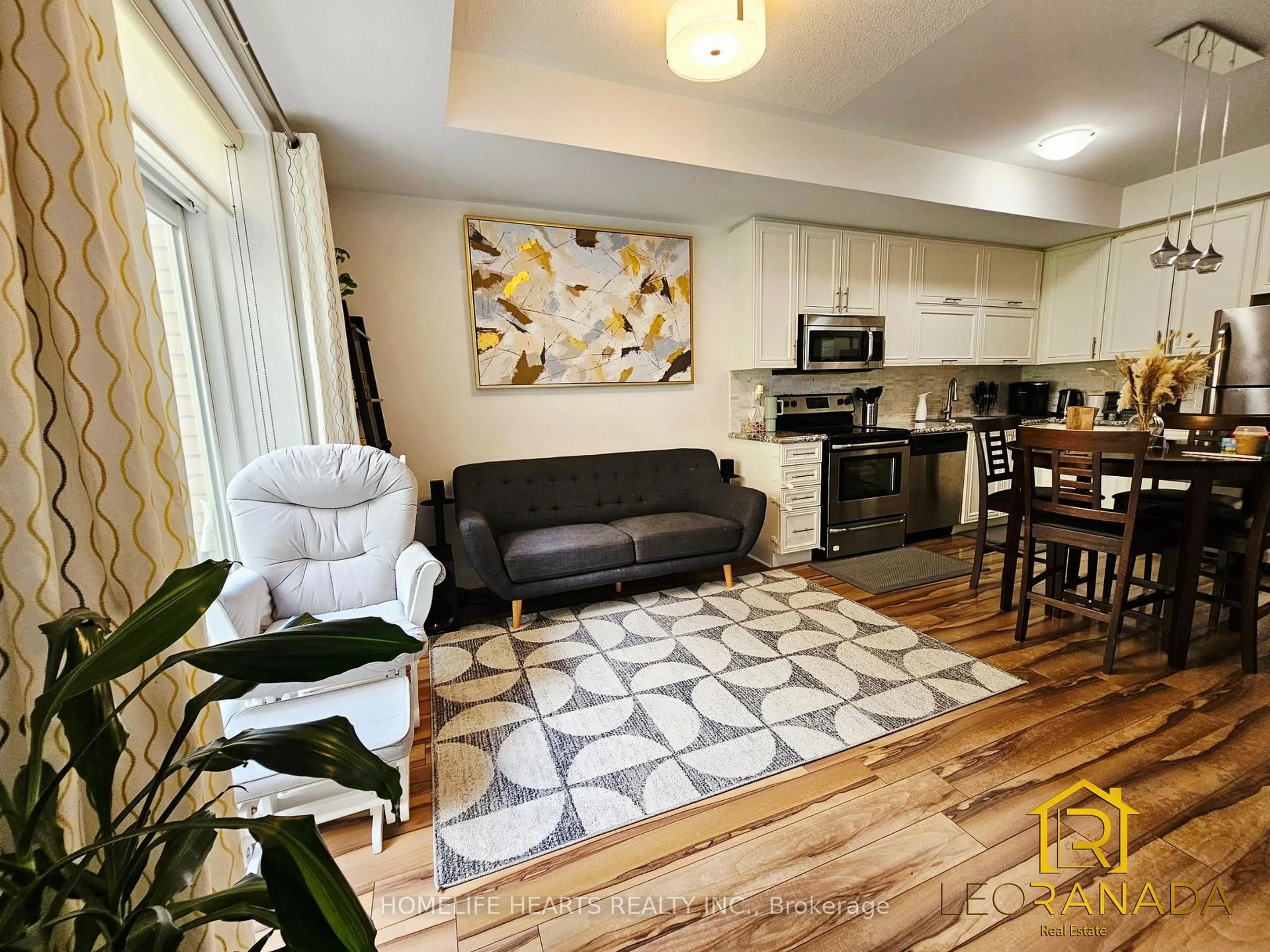 Living room with furniture, wood/laminate floor for 28 Prince Regent St #104, Markham Ontario L6C 0V5