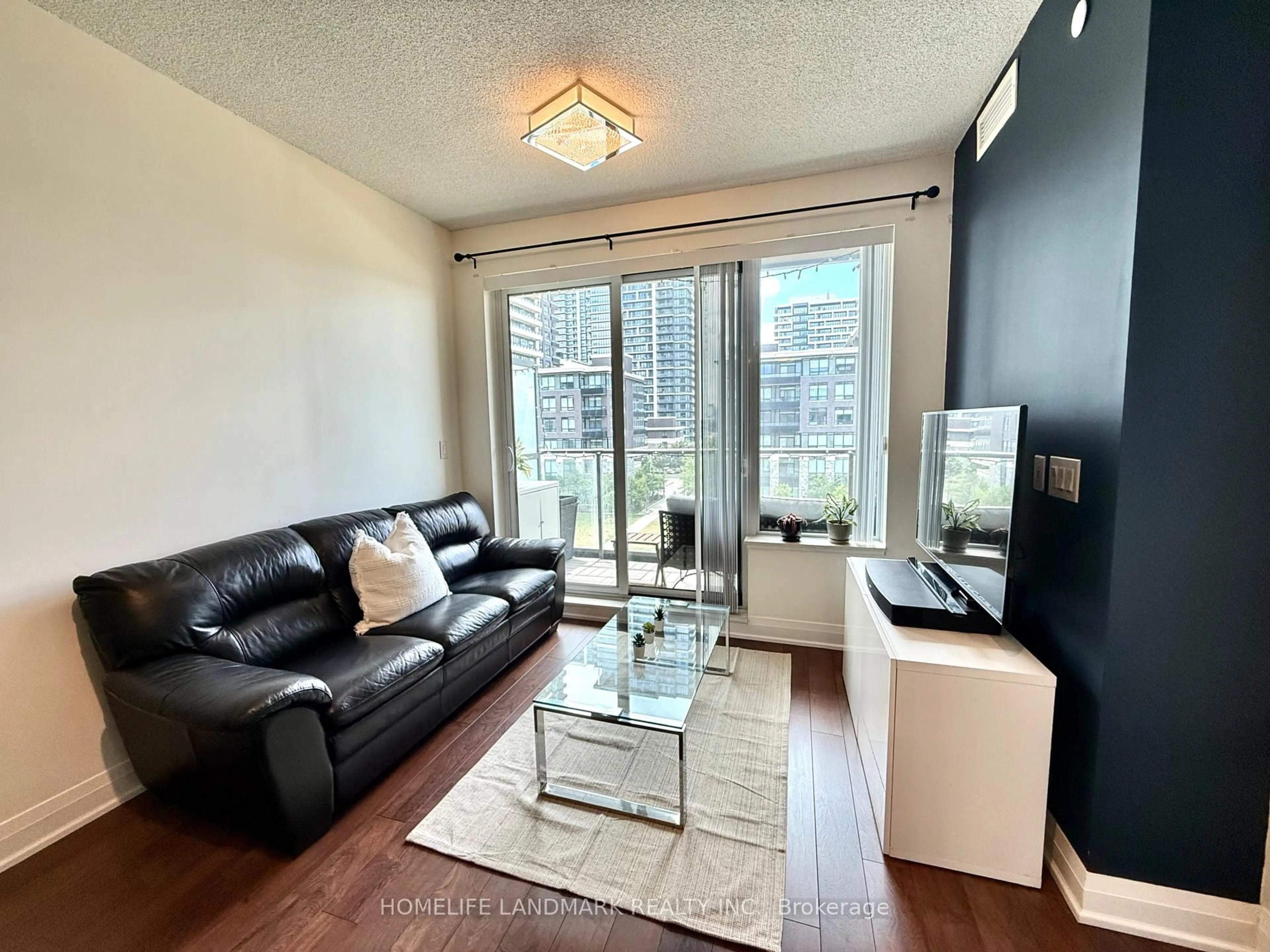 Living room with furniture, wood/laminate floor for 28 Uptown Dr #506, Markham Ontario L3R 5M8