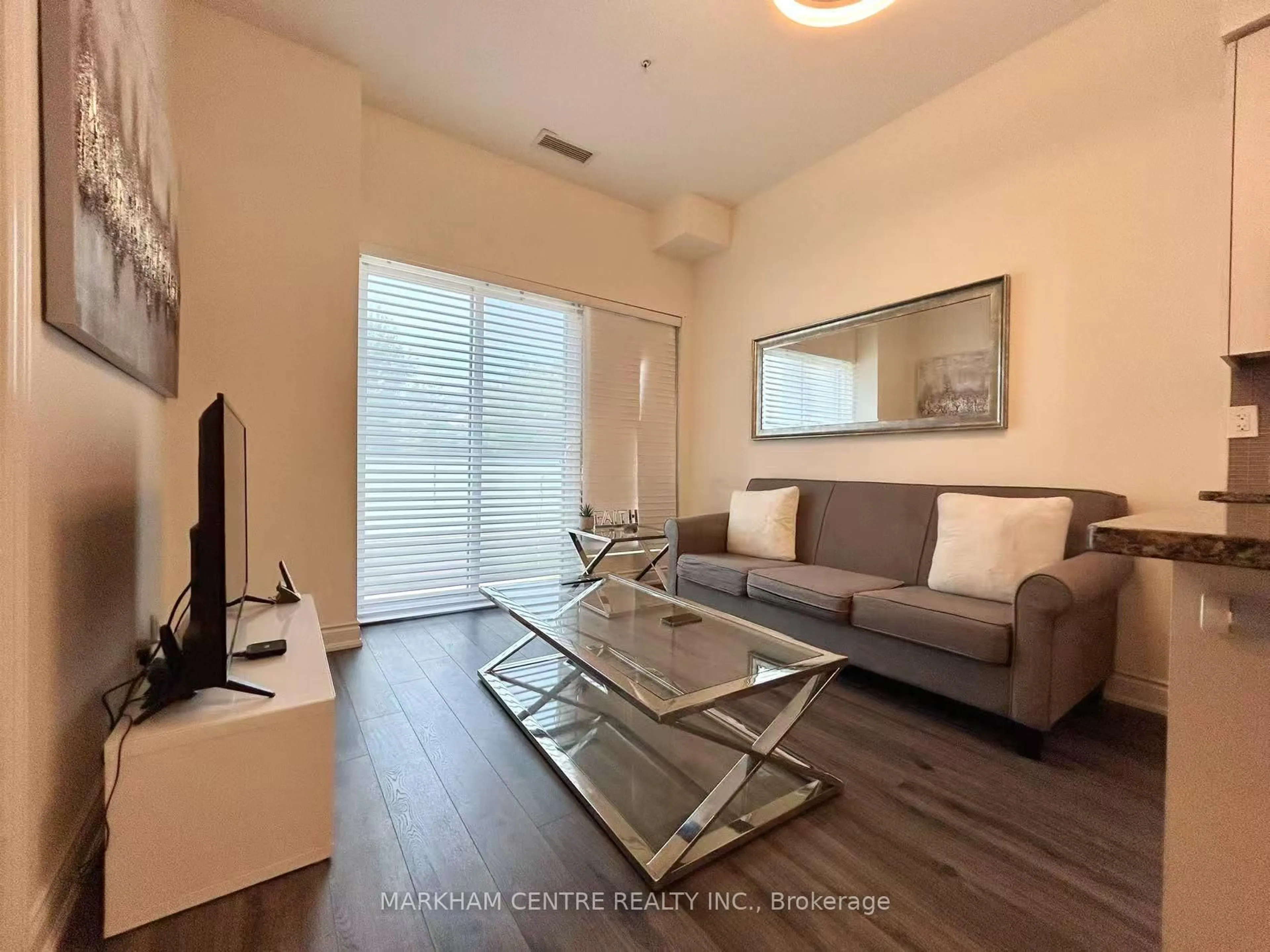Living room with furniture, wood/laminate floor for 9090 Yonge St #103B, Richmond Hill Ontario L4C 0Z1