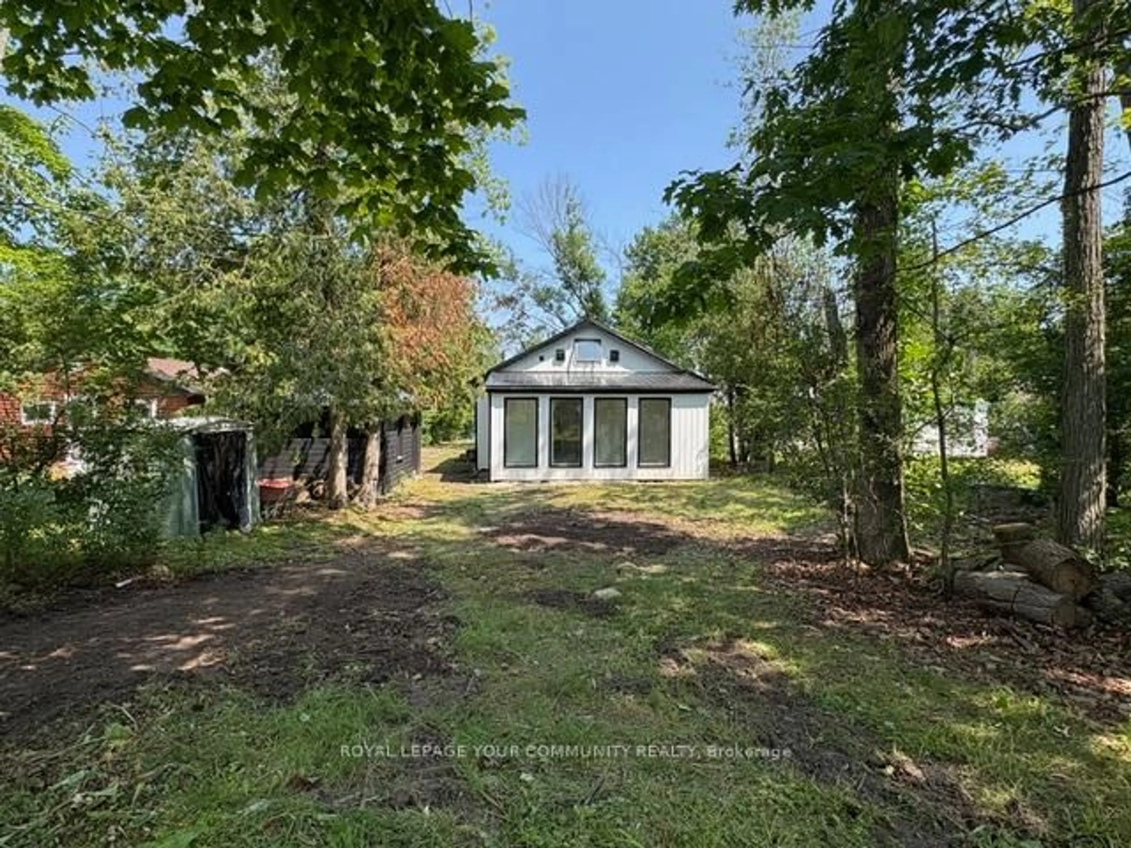 A pic from outside/outdoor area/front of a property/back of a property/a pic from drone, forest/trees view for 10 Snake Island Rd, Georgina Islands Ontario L4P 3E9