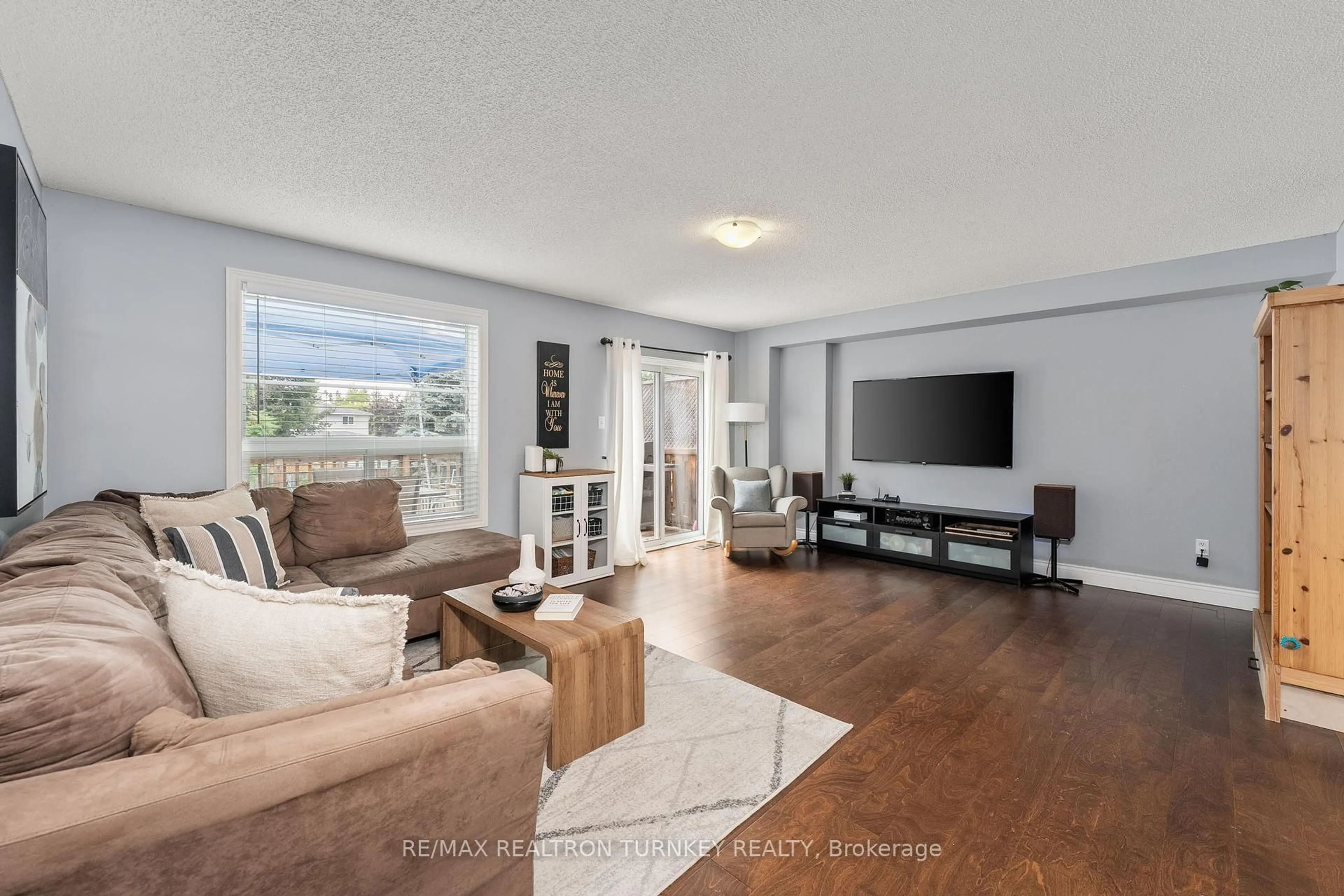 Living room with furniture, wood/laminate floor for 46 Hattie Crt, Georgina Ontario L4P 3Z8
