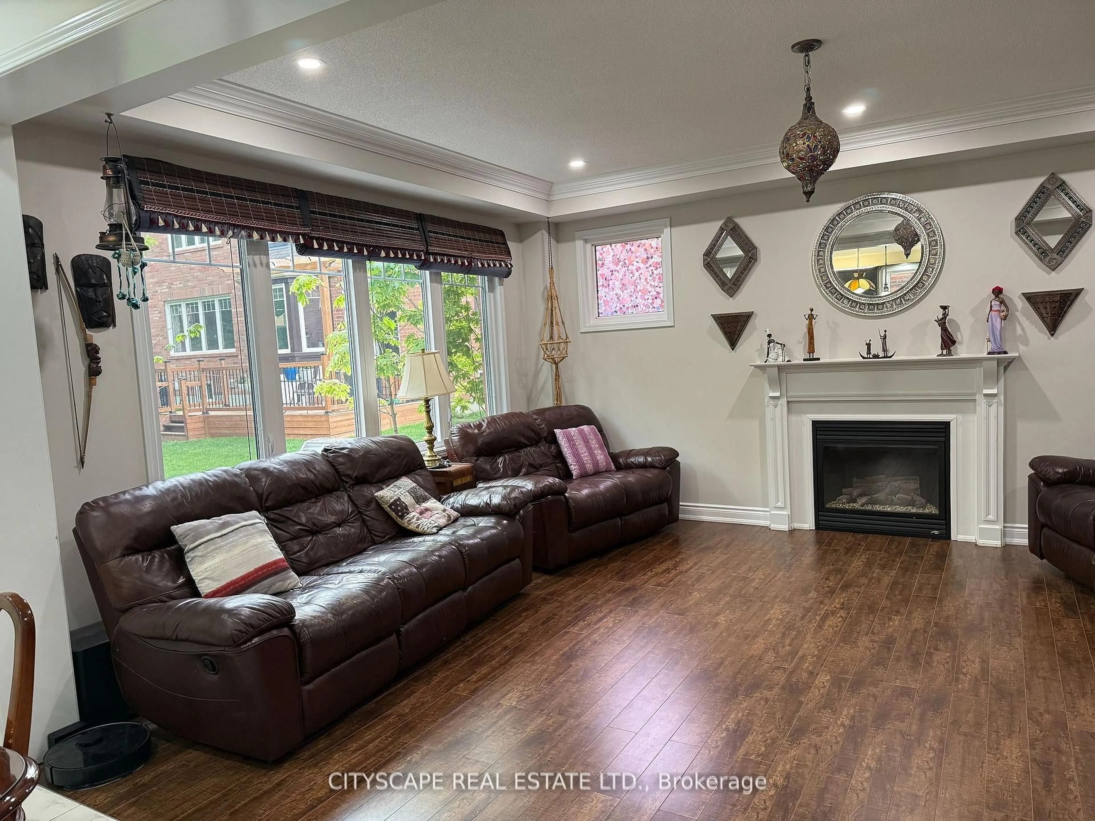 Living room with furniture, wood/laminate floor for 77 Bulmer Cres, Newmarket Ontario L3X 3K1