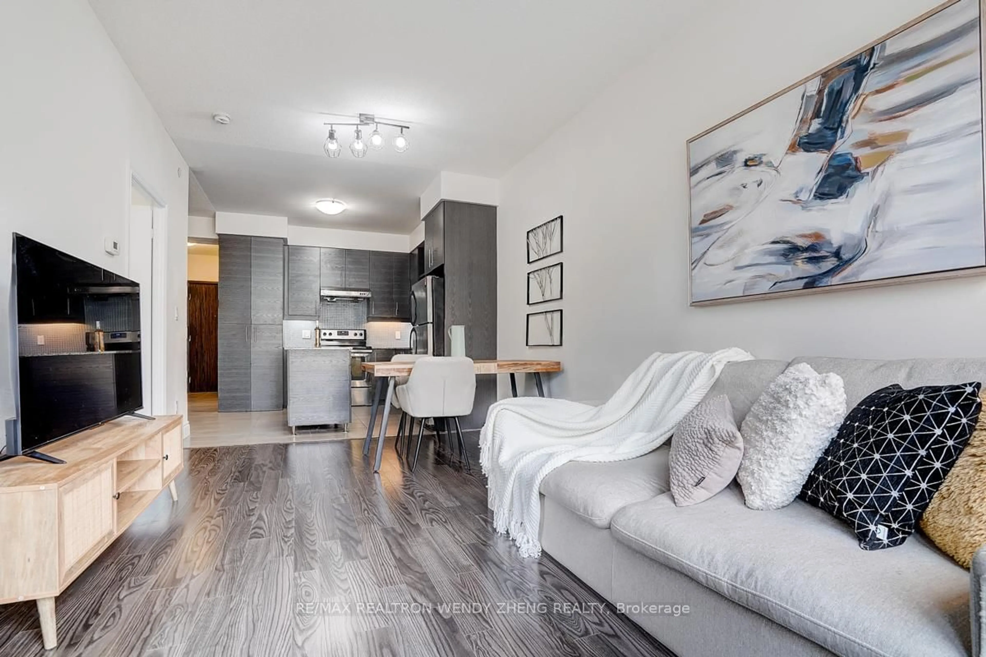 Living room with furniture, wood/laminate floor for 277 South Park Rd #201, Markham Ontario L3T 0B7
