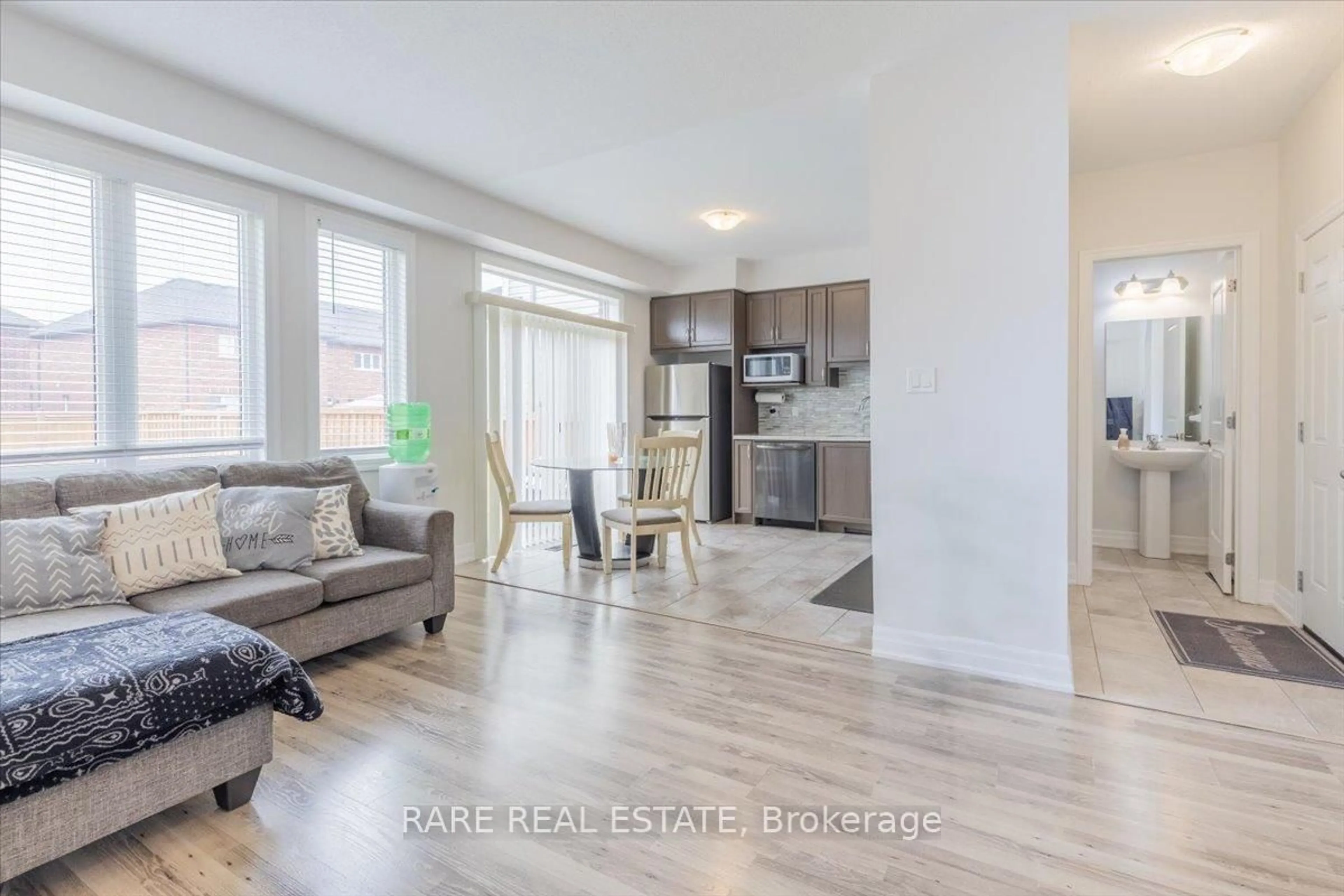 Living room with furniture, wood/laminate floor for 101 Wood Cres, Essa Ontario L3W 0M5