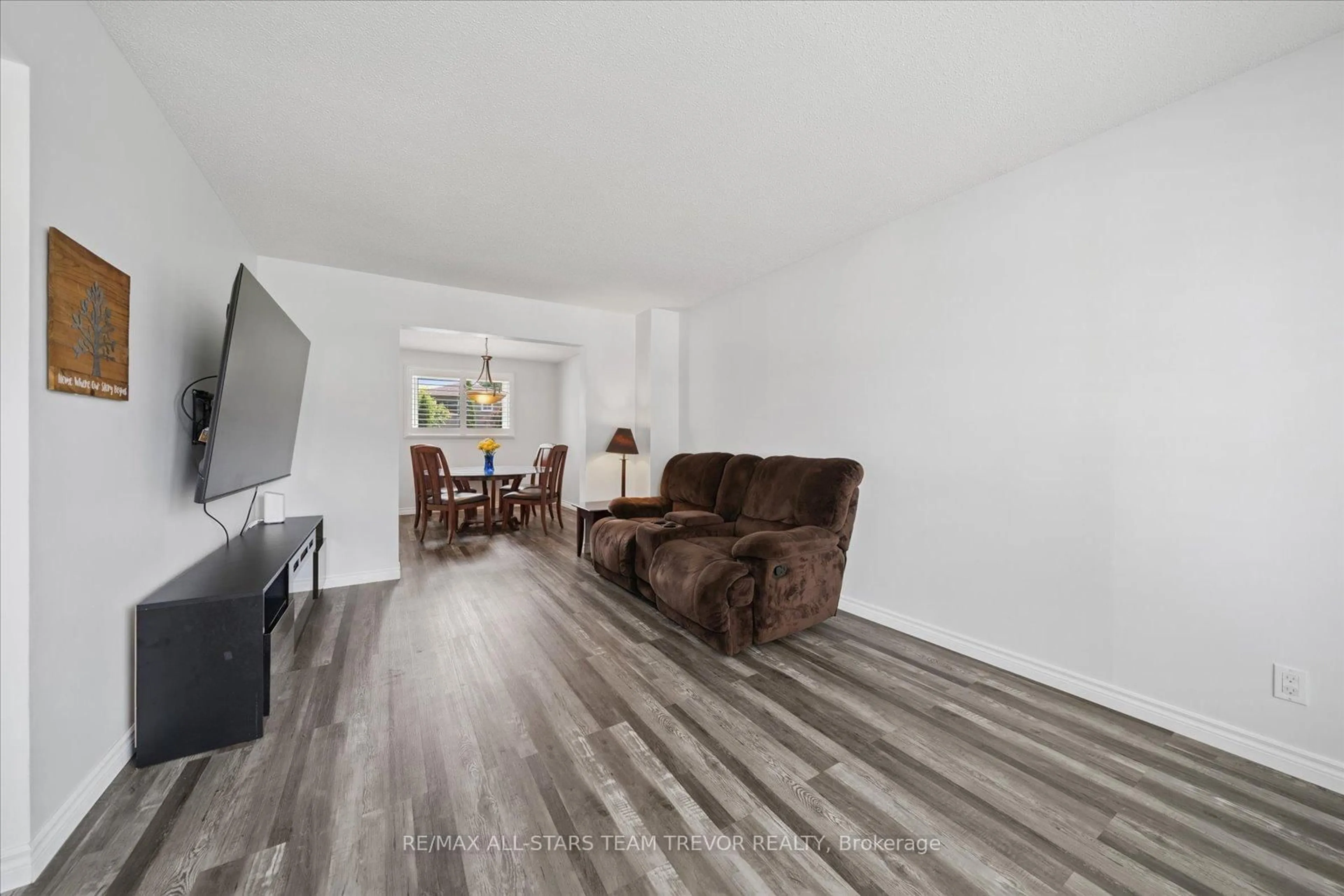 Living room with furniture, wood/laminate floor for 23 Panama Crt, Georgina Ontario L4P 3L7