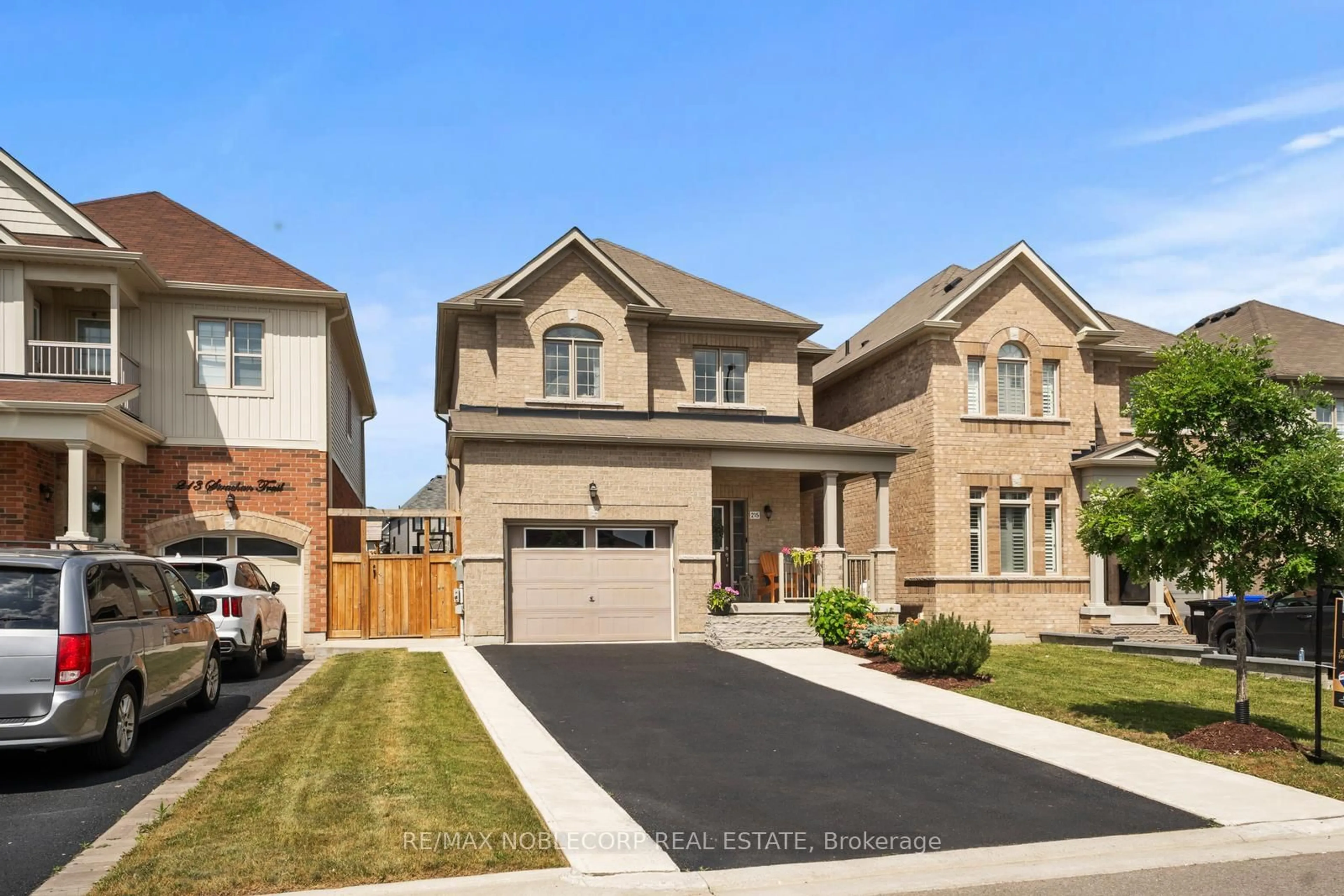 Home with brick exterior material, street for 215 Strachan Tr, New Tecumseth Ontario L0G 1A0