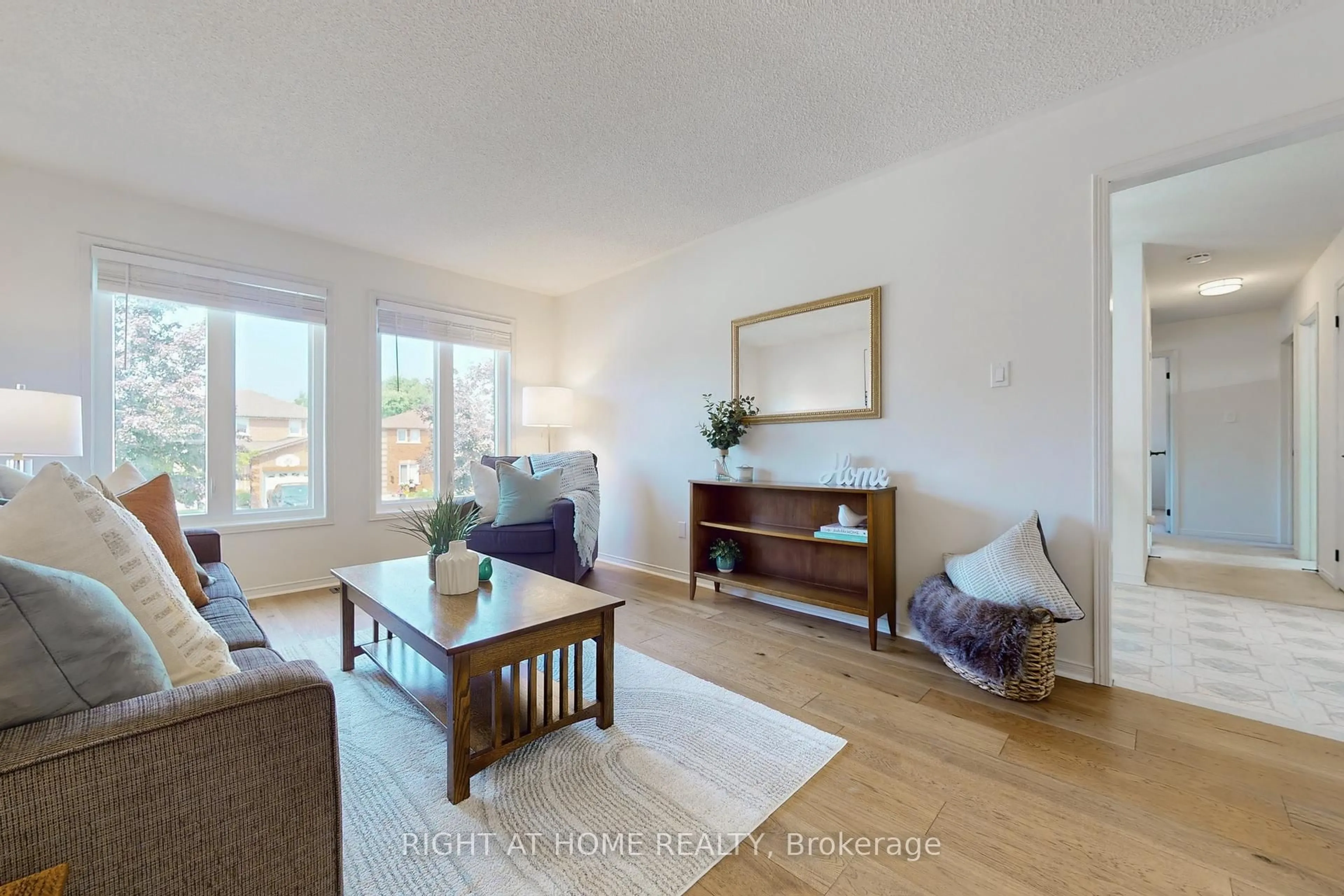 Living room with furniture, wood/laminate floor for 93 Compton Cres, Bradford West Gwillimbury Ontario L3Z 2X7