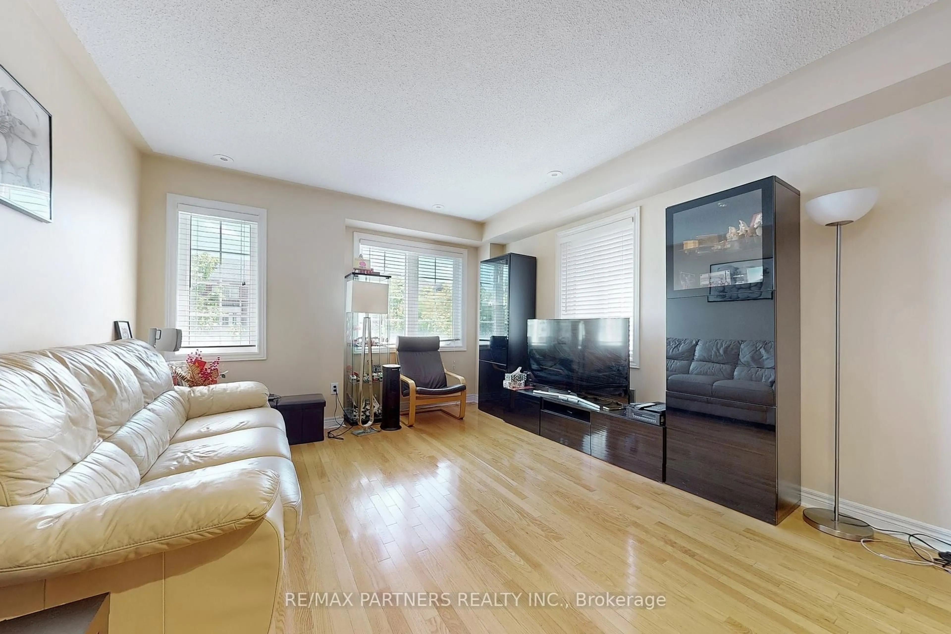 Living room with furniture, wood/laminate floor for 2452 Bur Oak Ave, Markham Ontario L6B 1J8