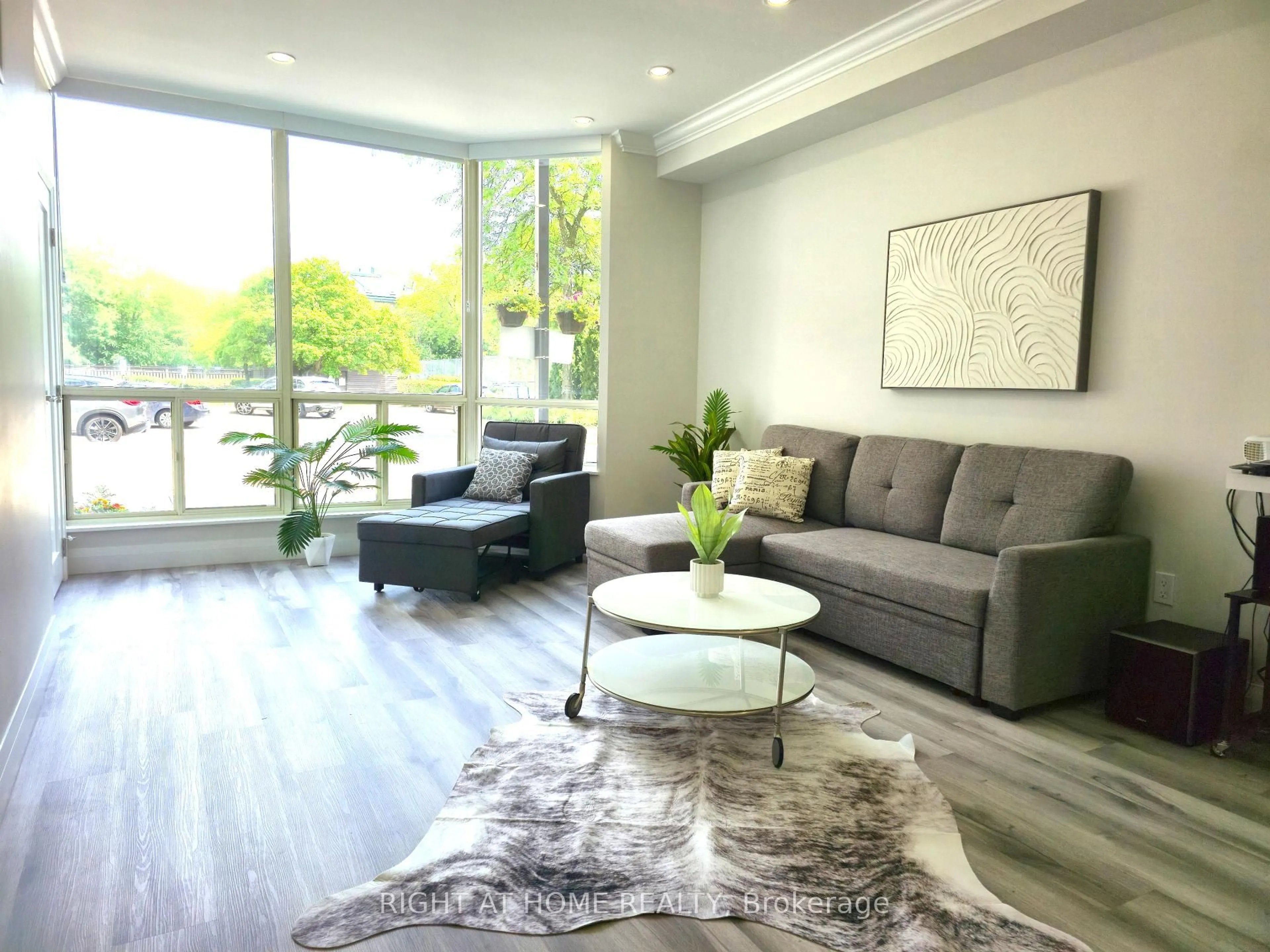 Living room with furniture, wood/laminate floor for 309 Major Mackenzie Dr #115, Richmond Hill Ontario L4C 9V5