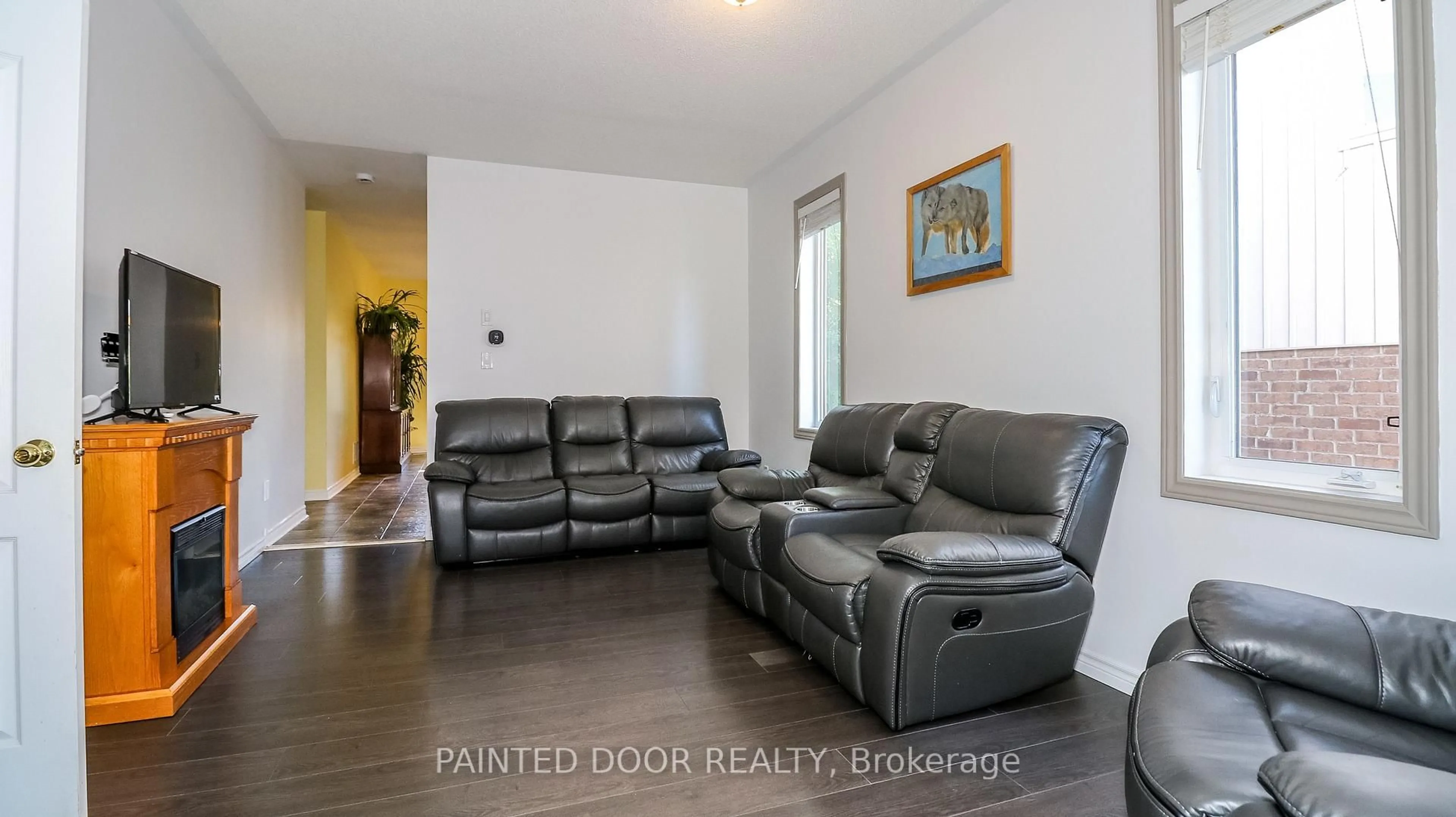 Living room with furniture, wood/laminate floor for 33 Legion Way, Essa Ontario L0M 1B5