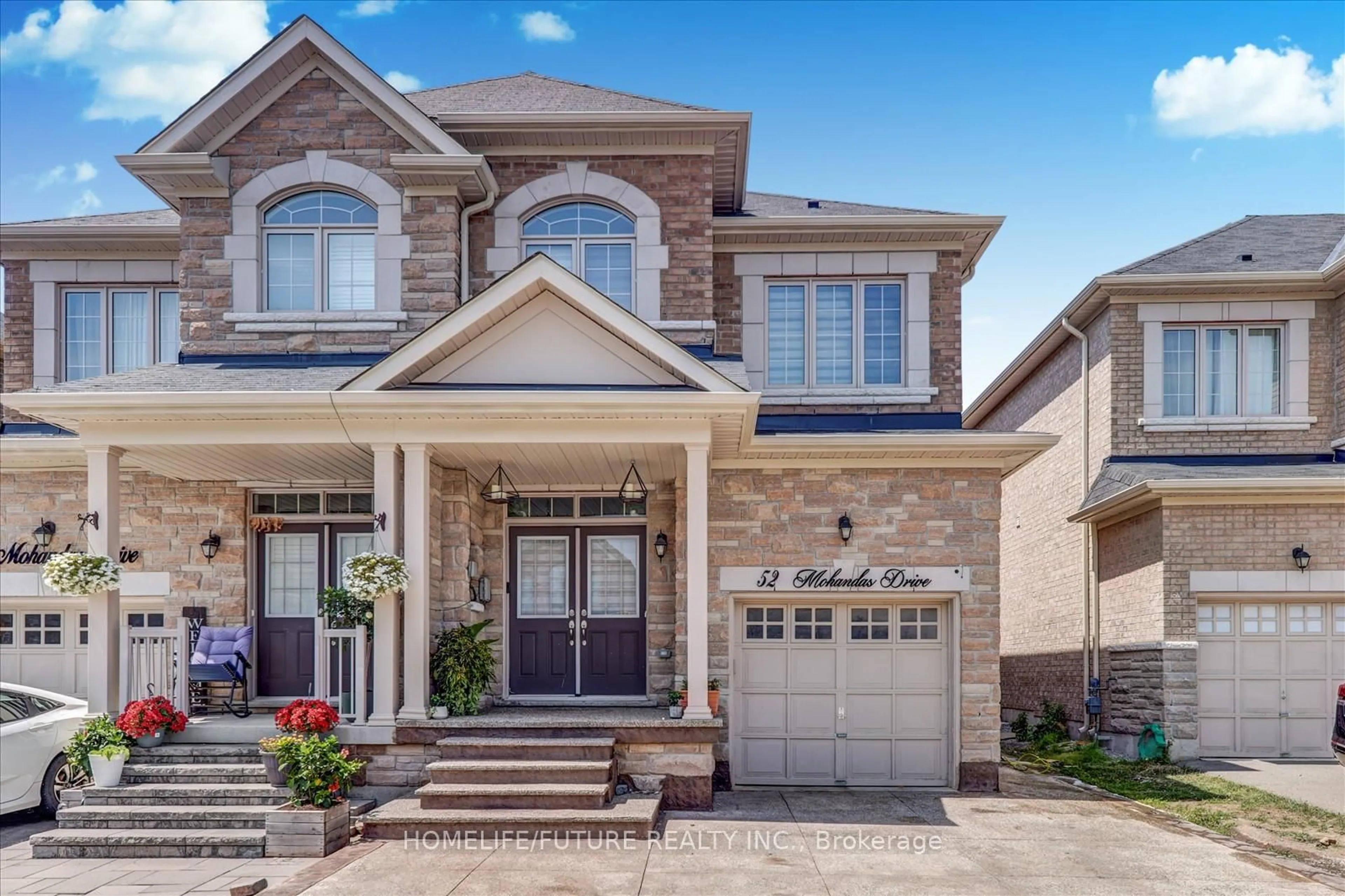 Home with brick exterior material, street for 52 Mohandas Dr, Markham Ontario L3S 0E5