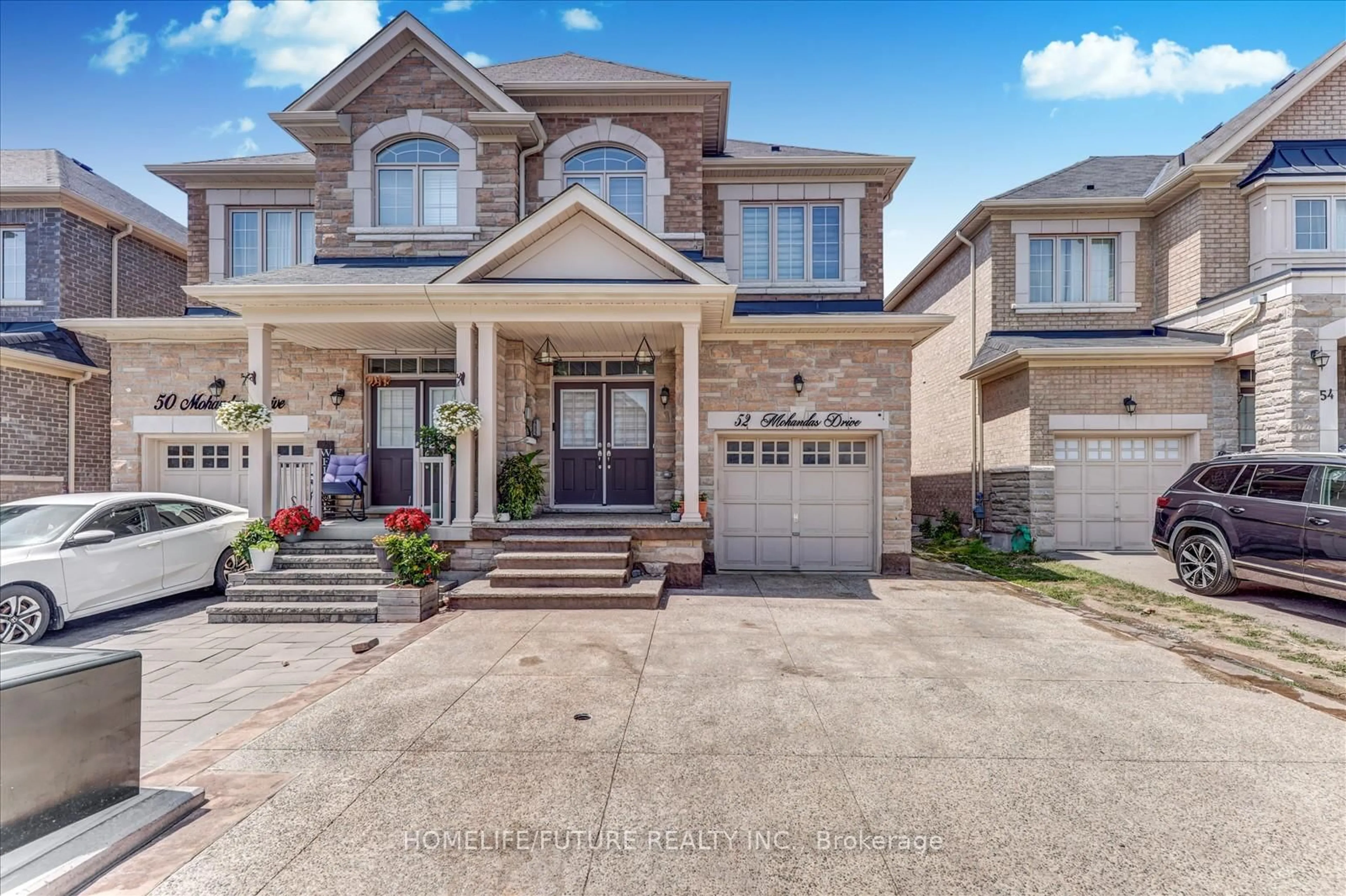 Home with brick exterior material, street for 52 Mohandas Dr, Markham Ontario L3S 0E5