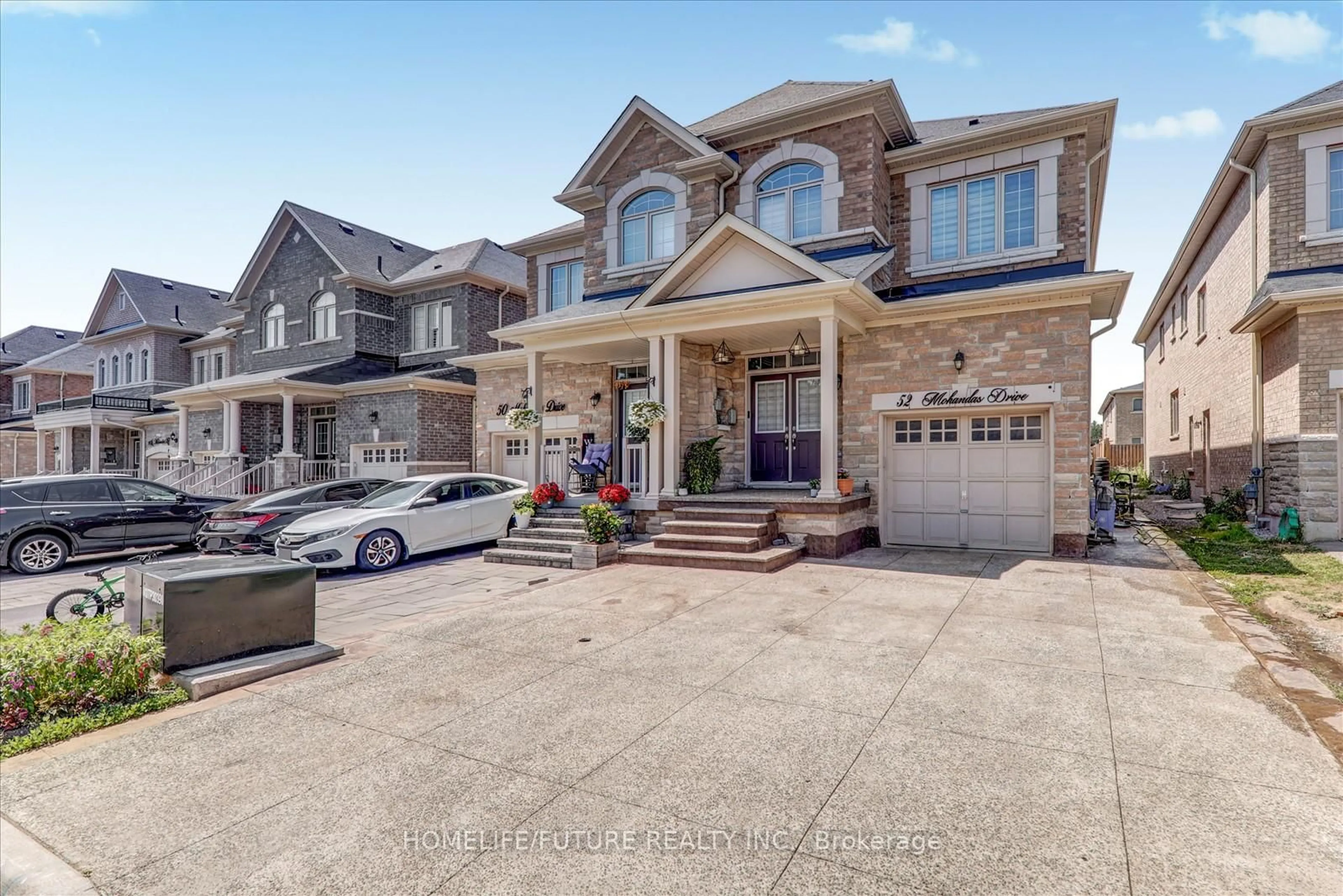 Home with brick exterior material, street for 52 Mohandas Dr, Markham Ontario L3S 0E5