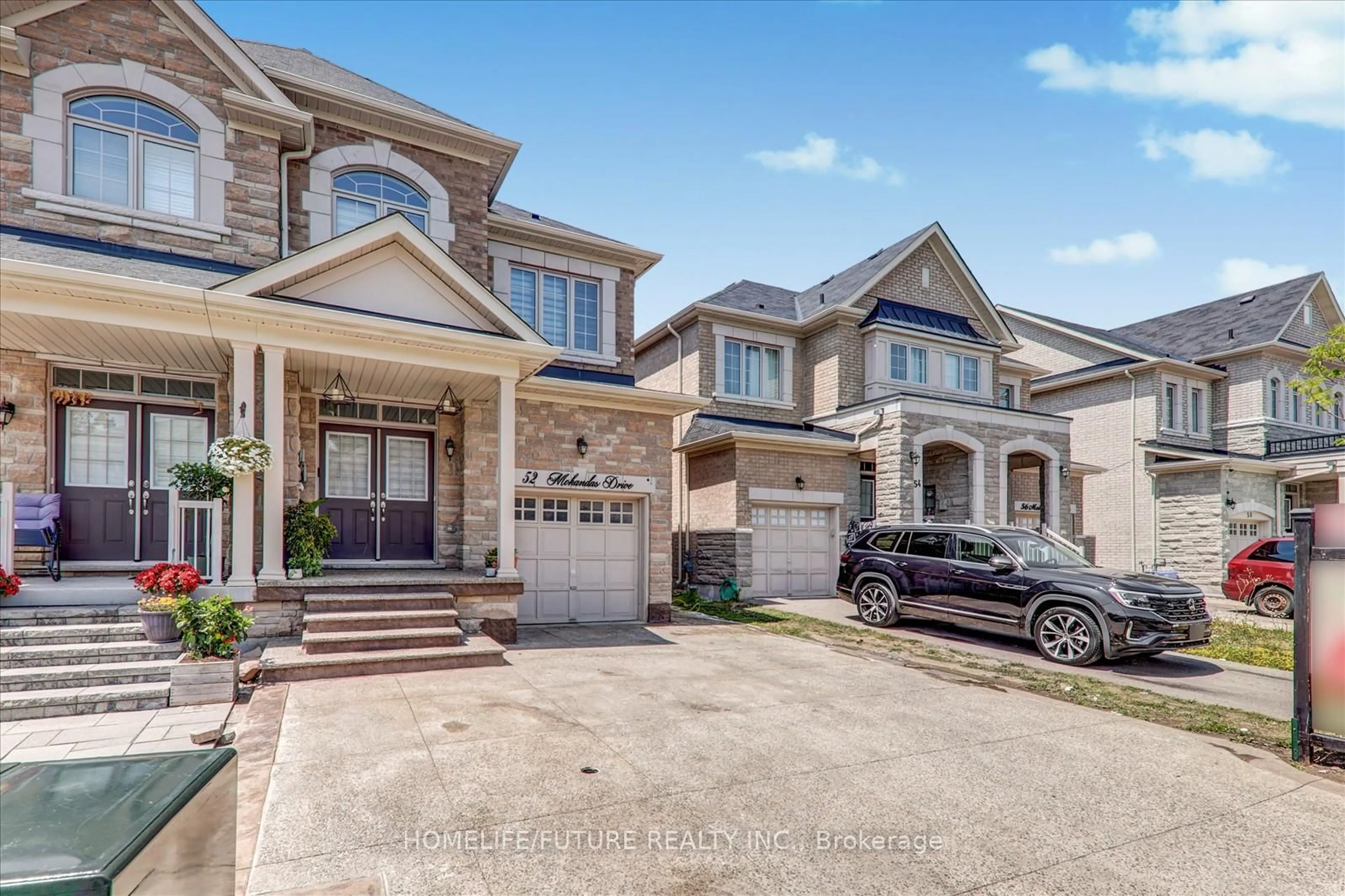 Home with brick exterior material, street for 52 Mohandas Dr, Markham Ontario L3S 0E5