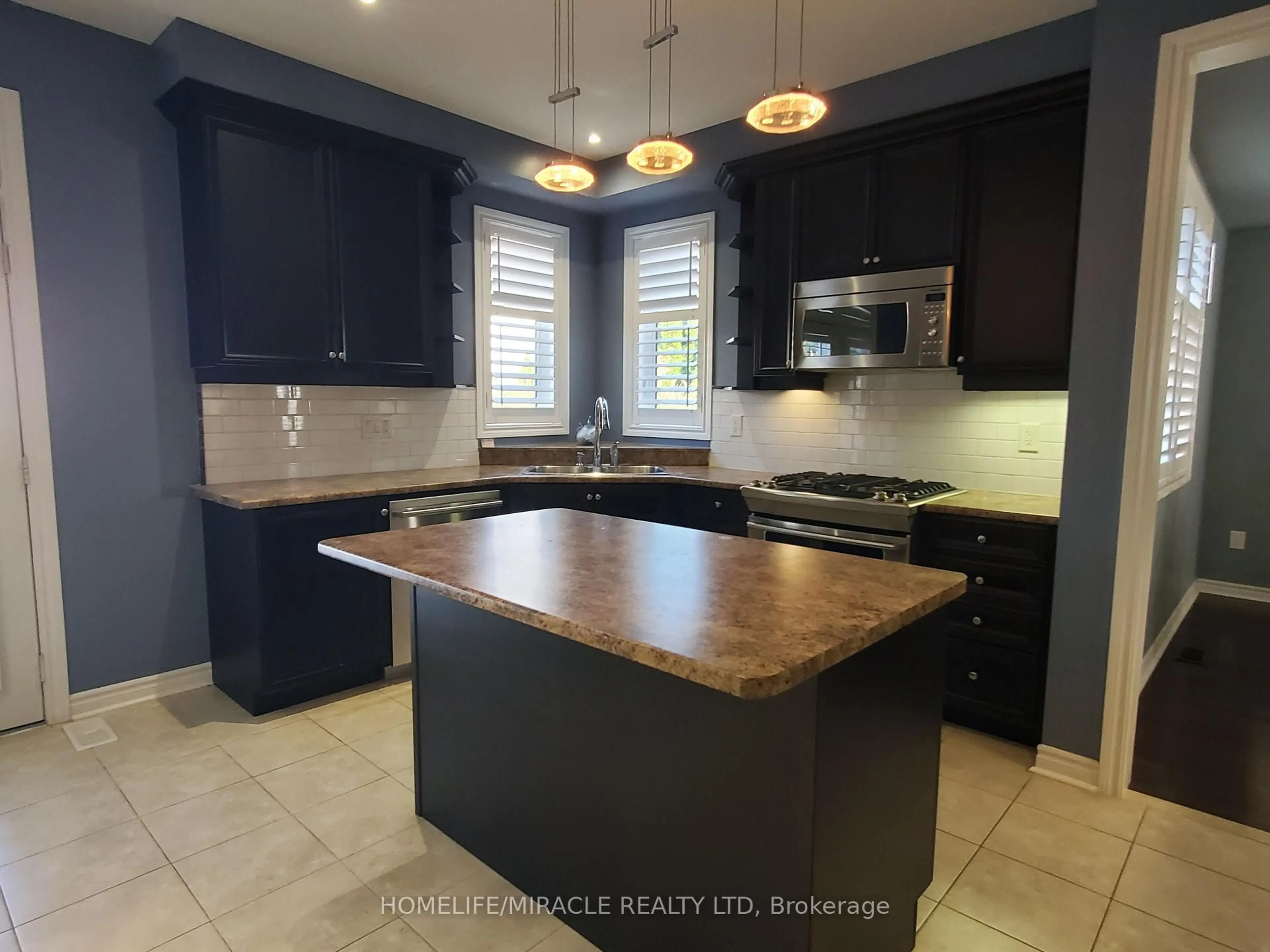 Open concept kitchen, ceramic/tile floor for 15 Lion's Crt, Essa Ontario L0M 1B5