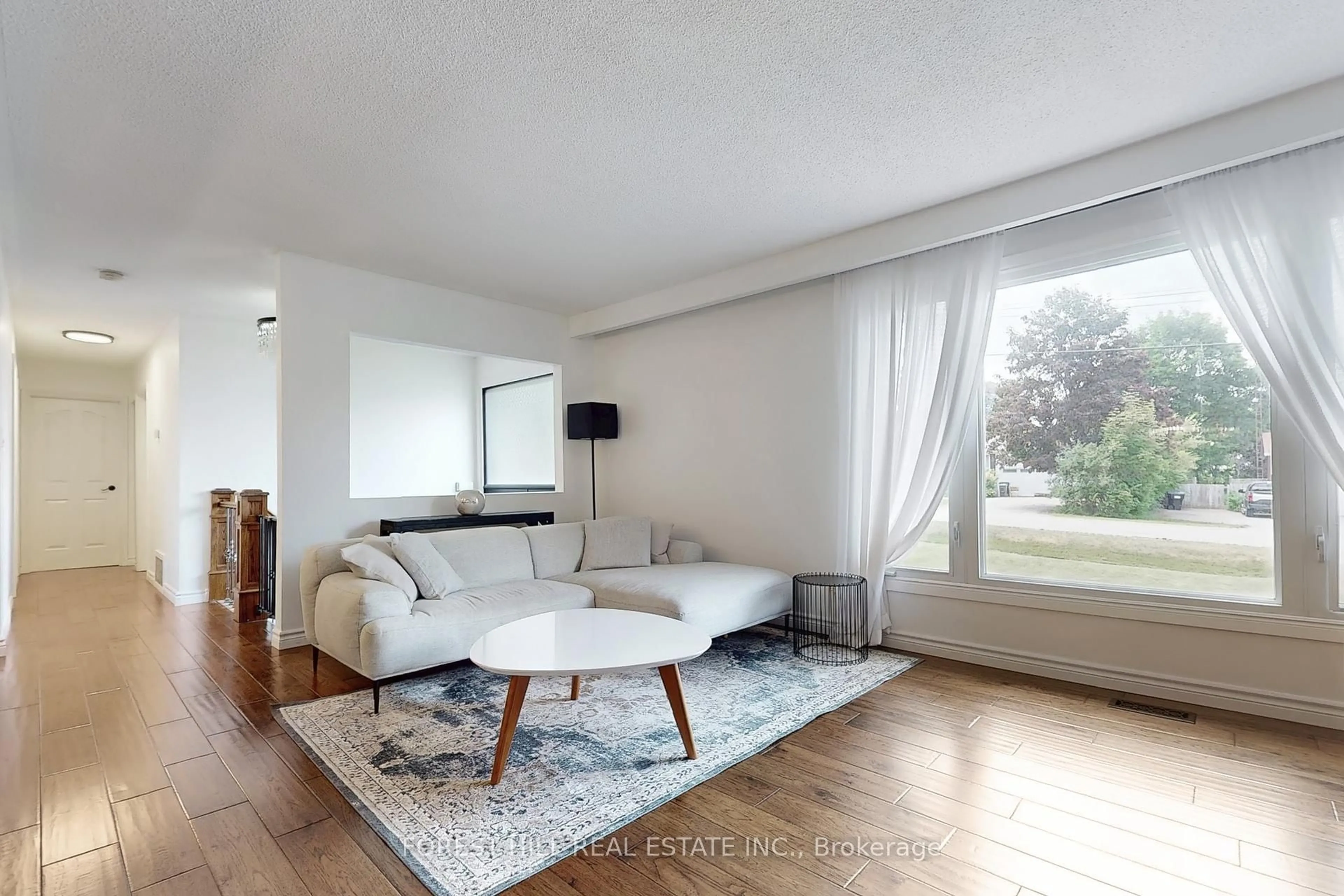 Living room with furniture, wood/laminate floor for 21 Lallien Dr, Bradford West Gwillimbury Ontario L0G 1B0