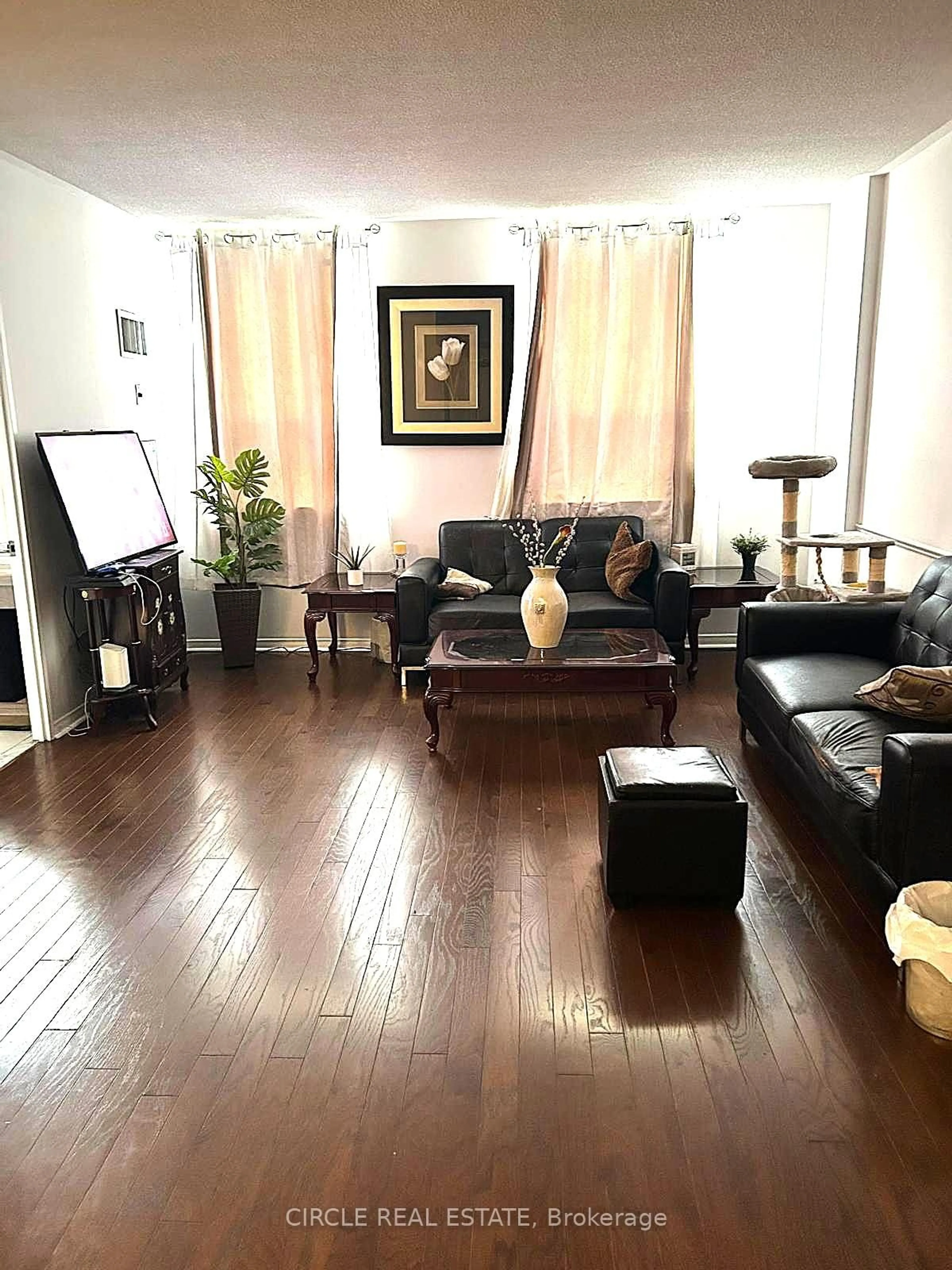 Living room with furniture, wood/laminate floor for 7398 Yonge St #112, Vaughan Ontario L4J 8J2